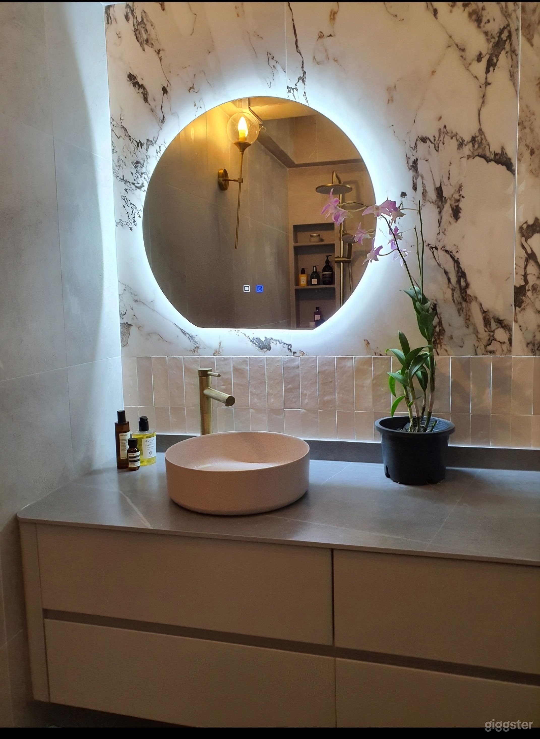 Marble tile feature wall in subtle pink, to exude femininity and simple luxury.