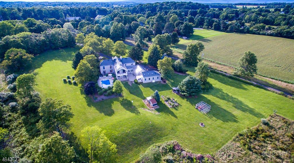 Drone shot of the property. A total of over 3.5 lush acres with wide open fields and beautiful landscaping.