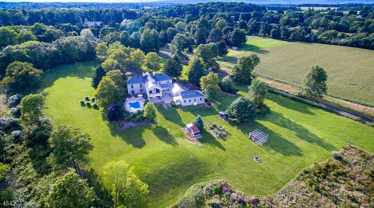  Drone shot of the property. A total of over 3.5 lush acres with wide open fields and beautiful landscaping. 
