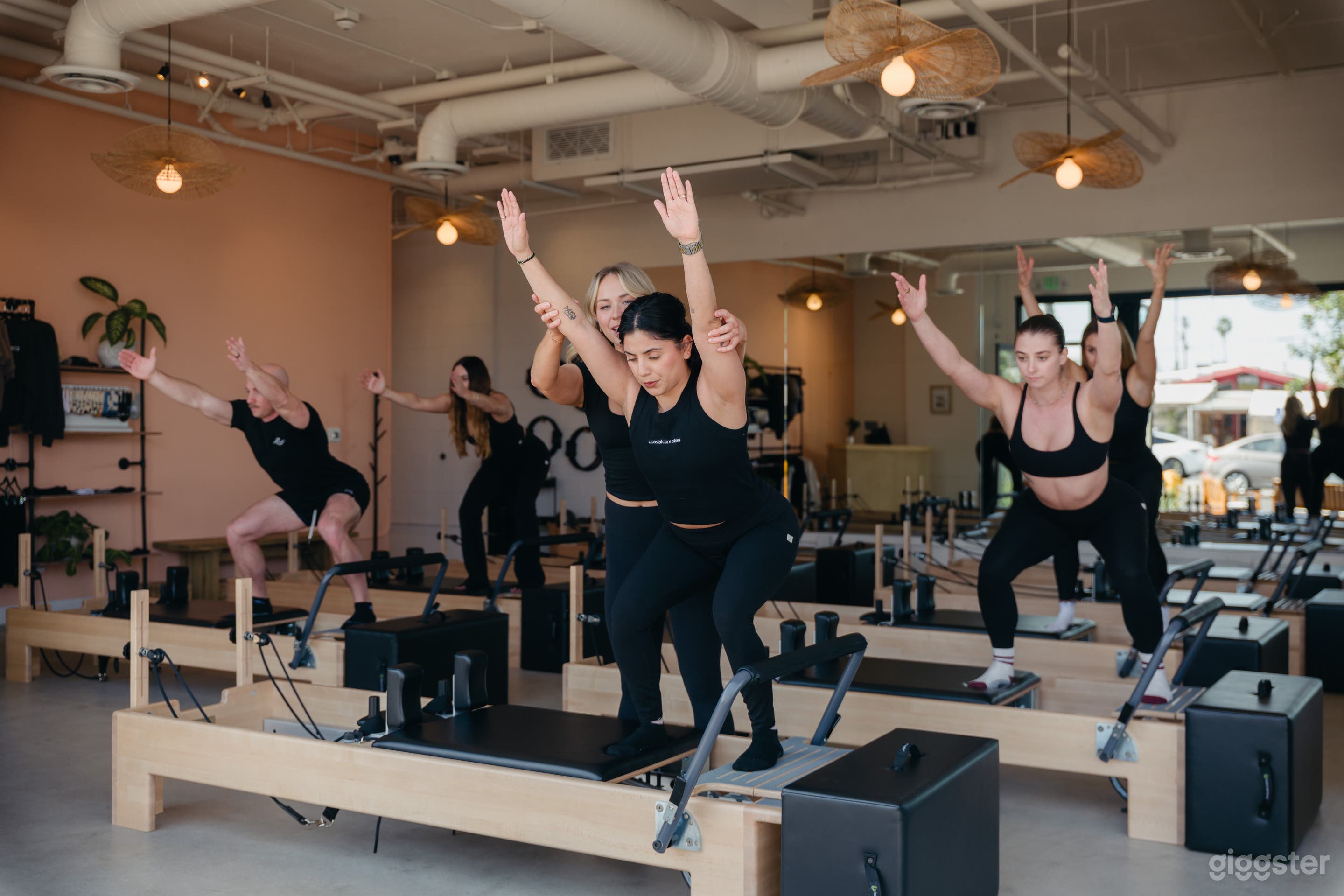 Group reformer-pilates class. 9 reformers. Bright, clean, airy, coastal vibe