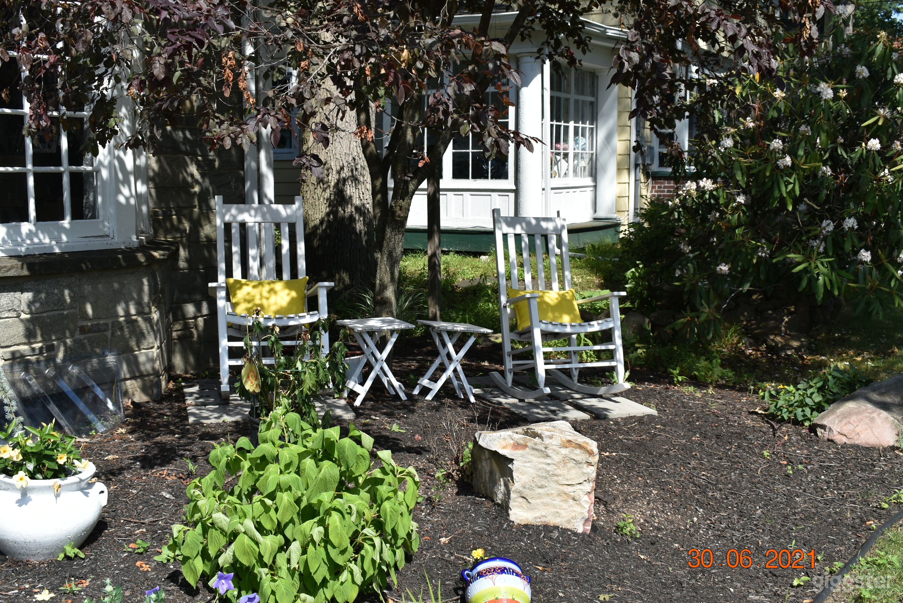Quaint evening sitting area in lieu of a front porch.