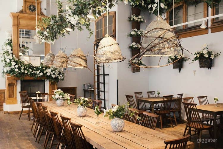 Main dining room with rustic farm tables and decorative fireplace