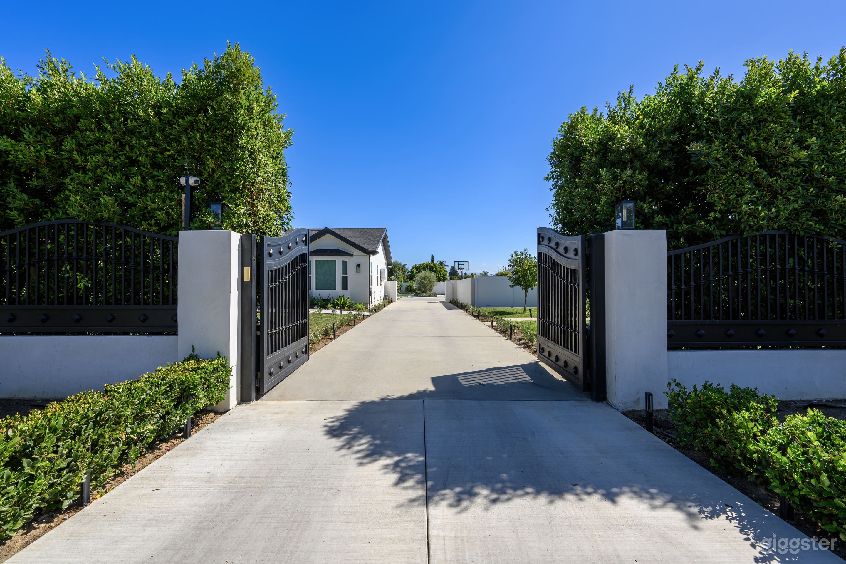 Long, straight 200-foot driveway offering a clear, open view from end to end, ideal for vehicle access or cinematic shots.