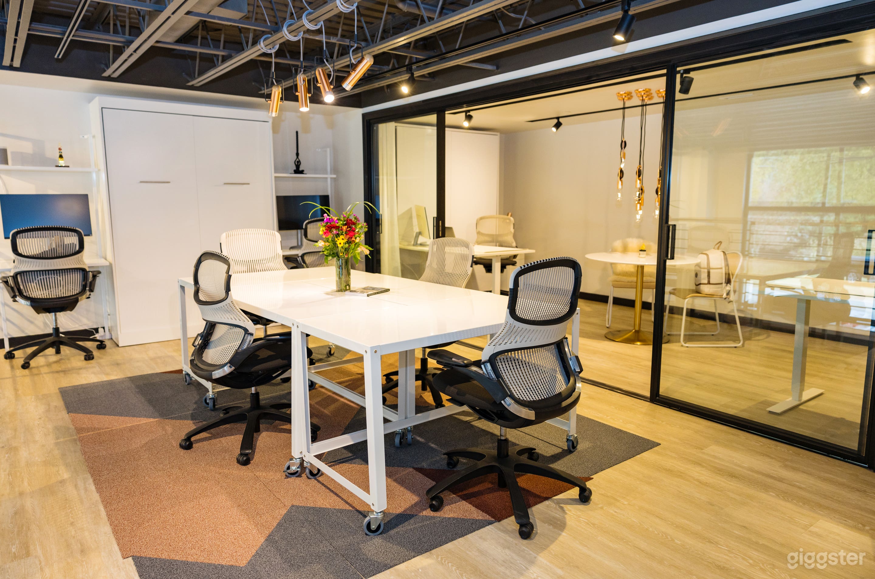 Upstairs Loft overlooks living area and kitchen. Flexible space, currently set up as design studio office, furniture is moveable. Sliding glass doors and sheer curtains can be closed to separate back bedroom/office. Murphy bed built into wall.