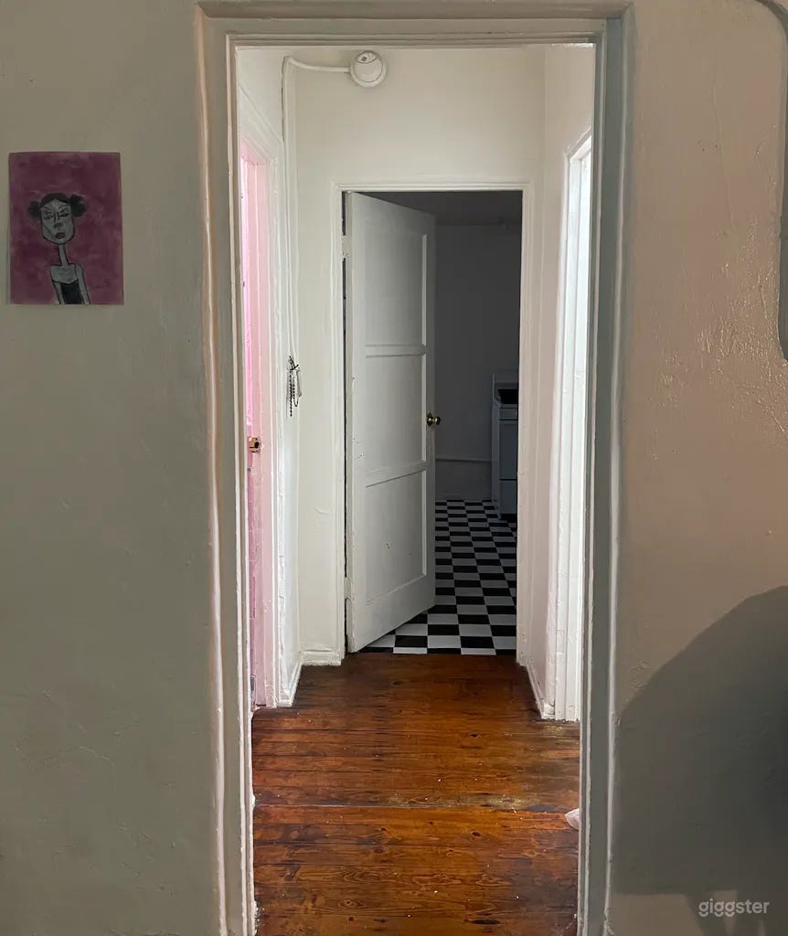 Hallway that connects bathroom, kitchen, and separate vanity style closet
