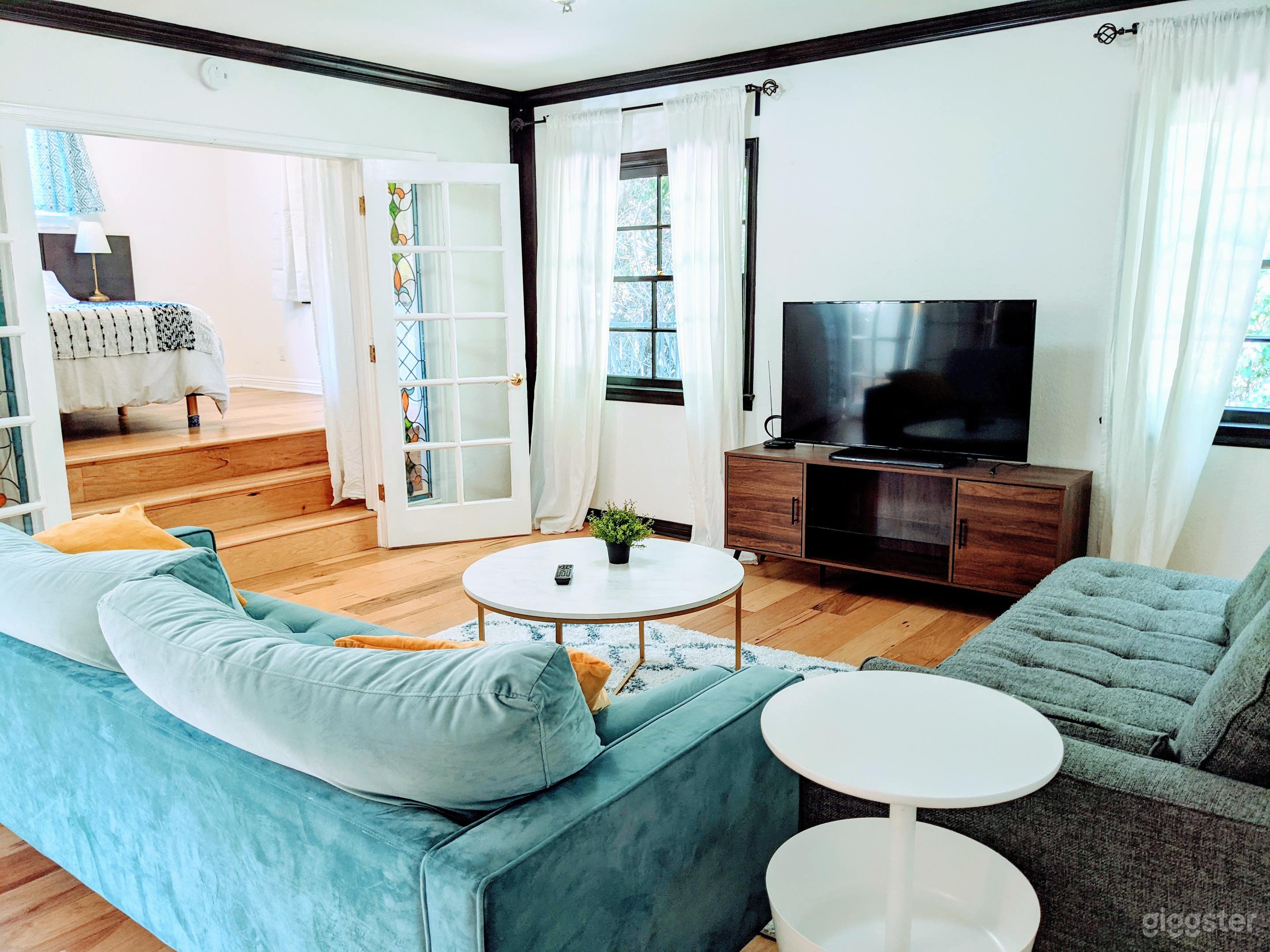 Living room, sofas, TV, French Door to bedroom 3