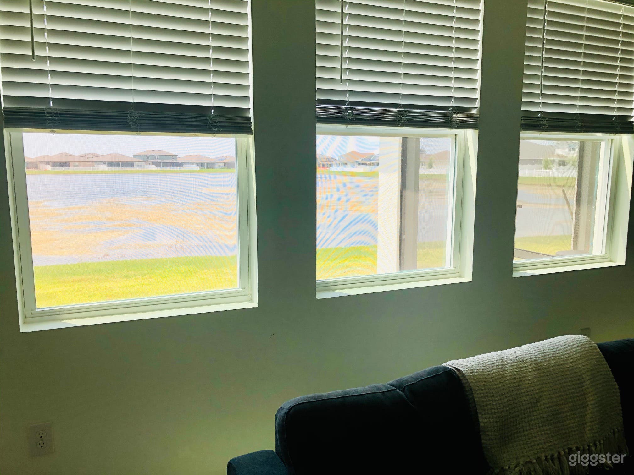 Living room windows to backyard and pond/water views