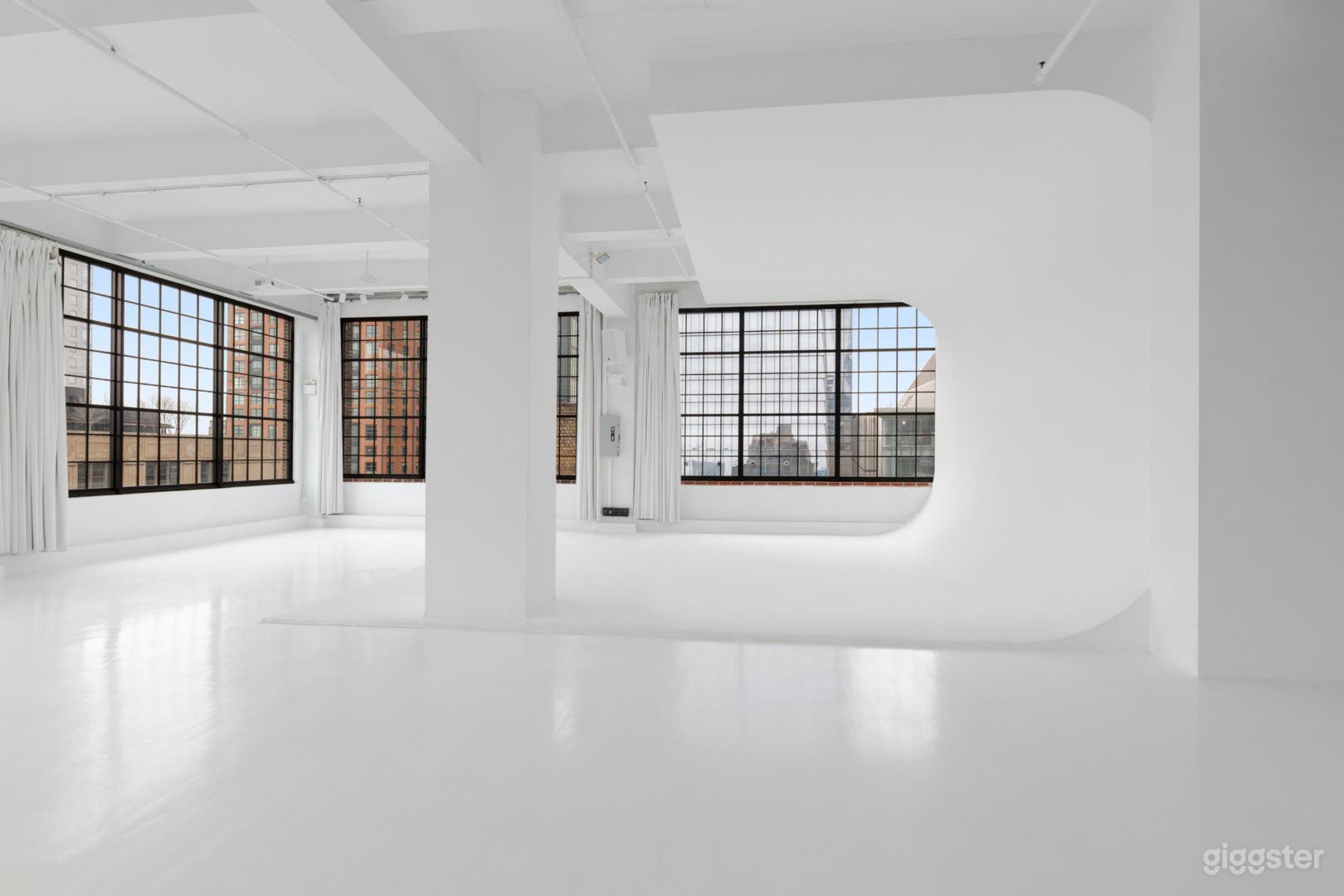 Wide-open loft studio configured for photography, filming, and intimate events.