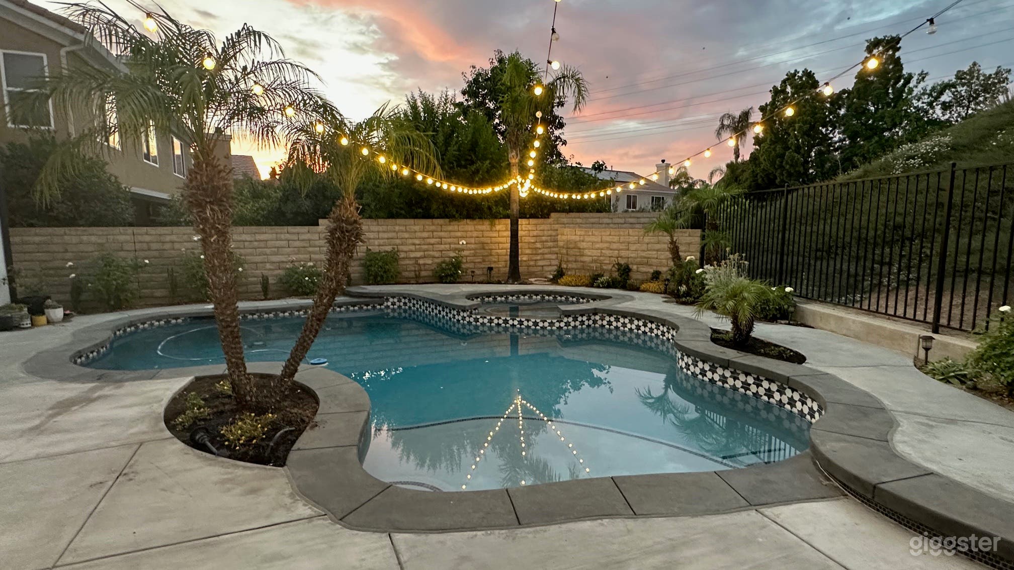 Pool at dusk - overhead string lights.