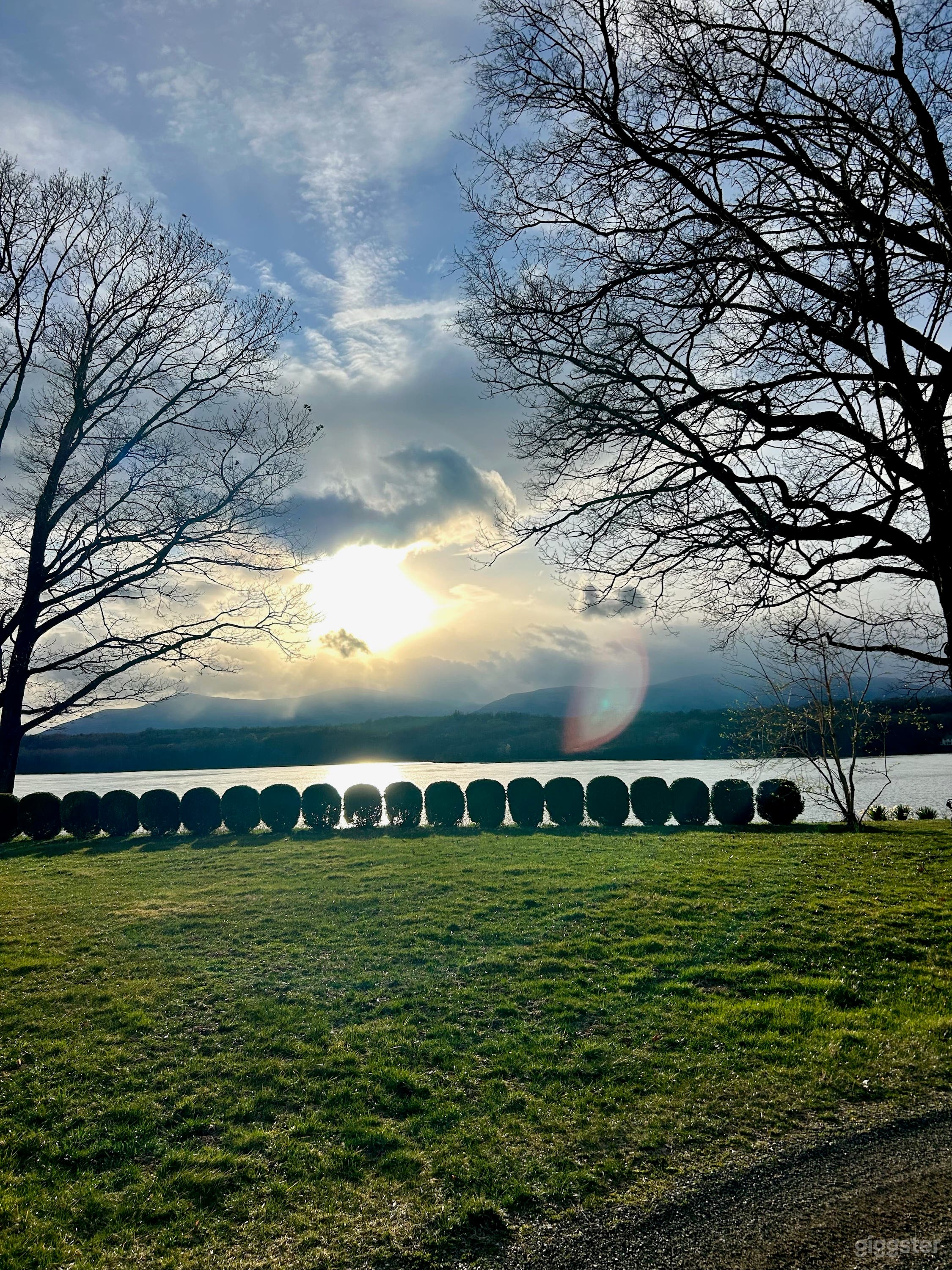Sunset through the clouds over the river