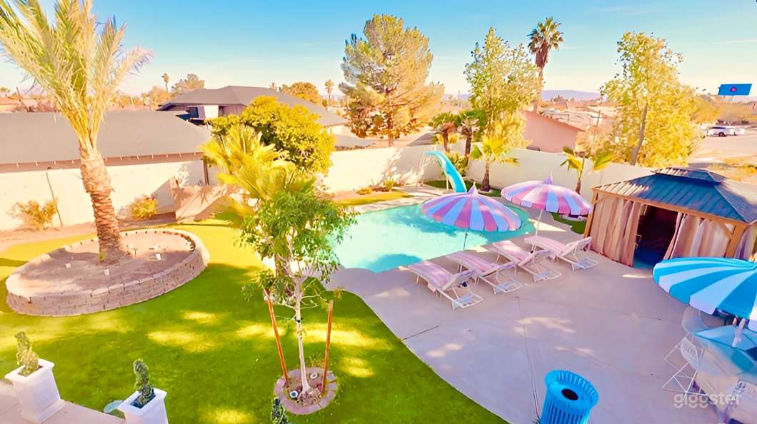 Pastel Pool Oasis with Palm Views Photo 1