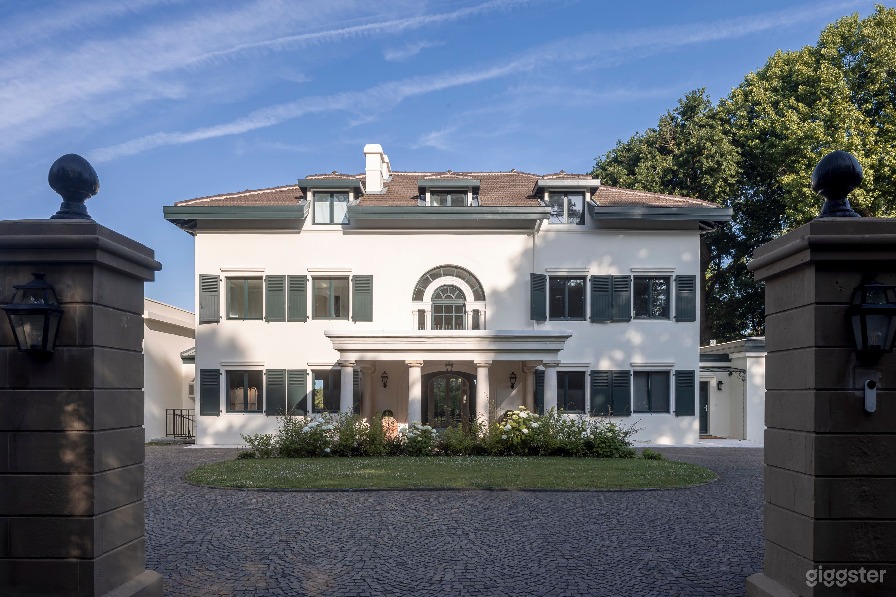 Elegant Estate Backyard with Garden and Driveway Photo 4