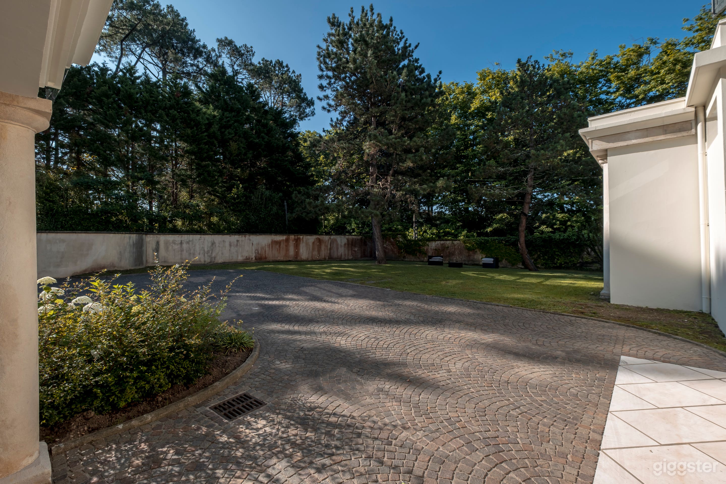 Elegant Estate Backyard with Garden and Driveway Photo 2