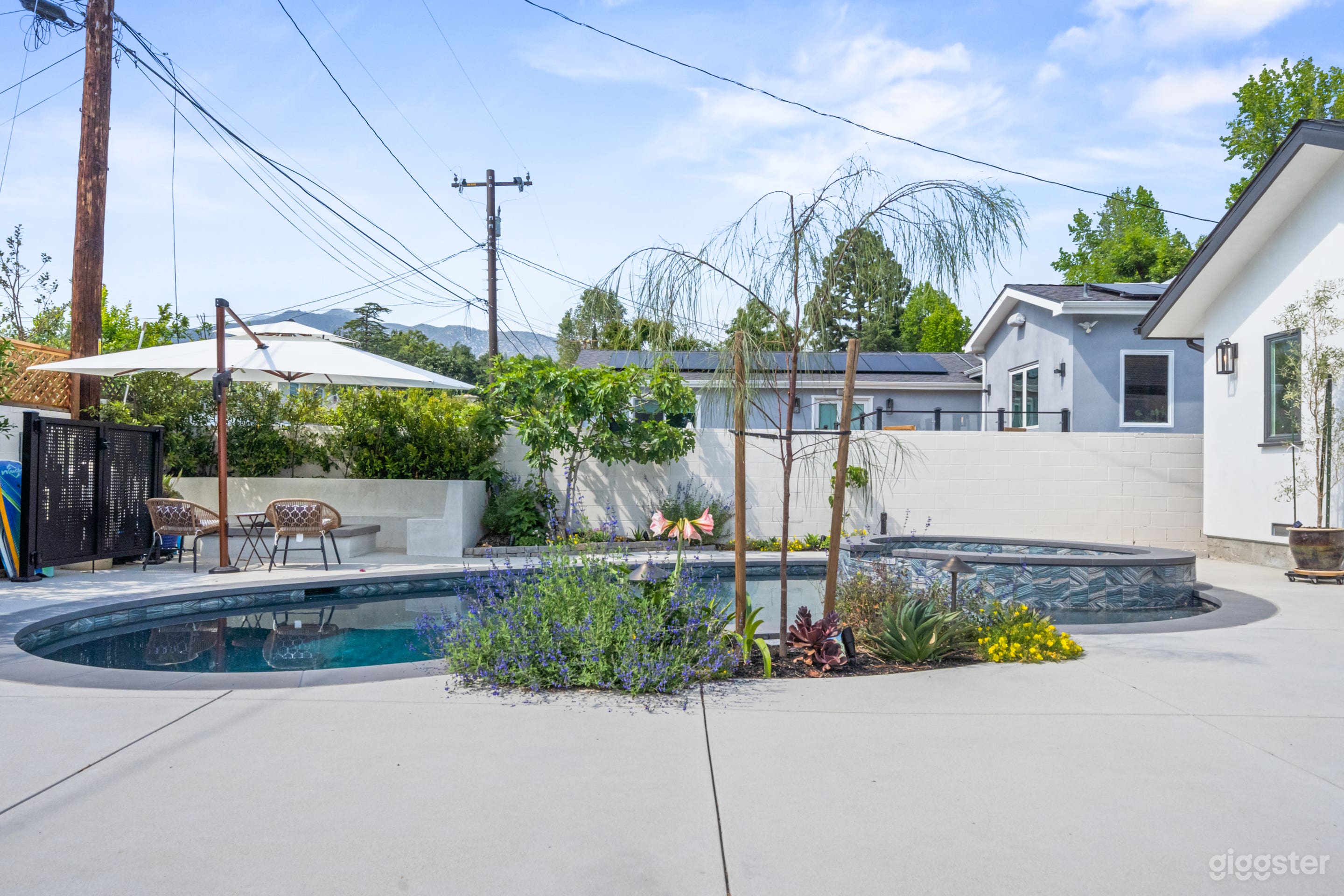 Host your next getaway or small celebration in this stylish backyard oasis — complete with a private pool, shaded seating, lush landscaping, and plenty of space to unwind or entertain