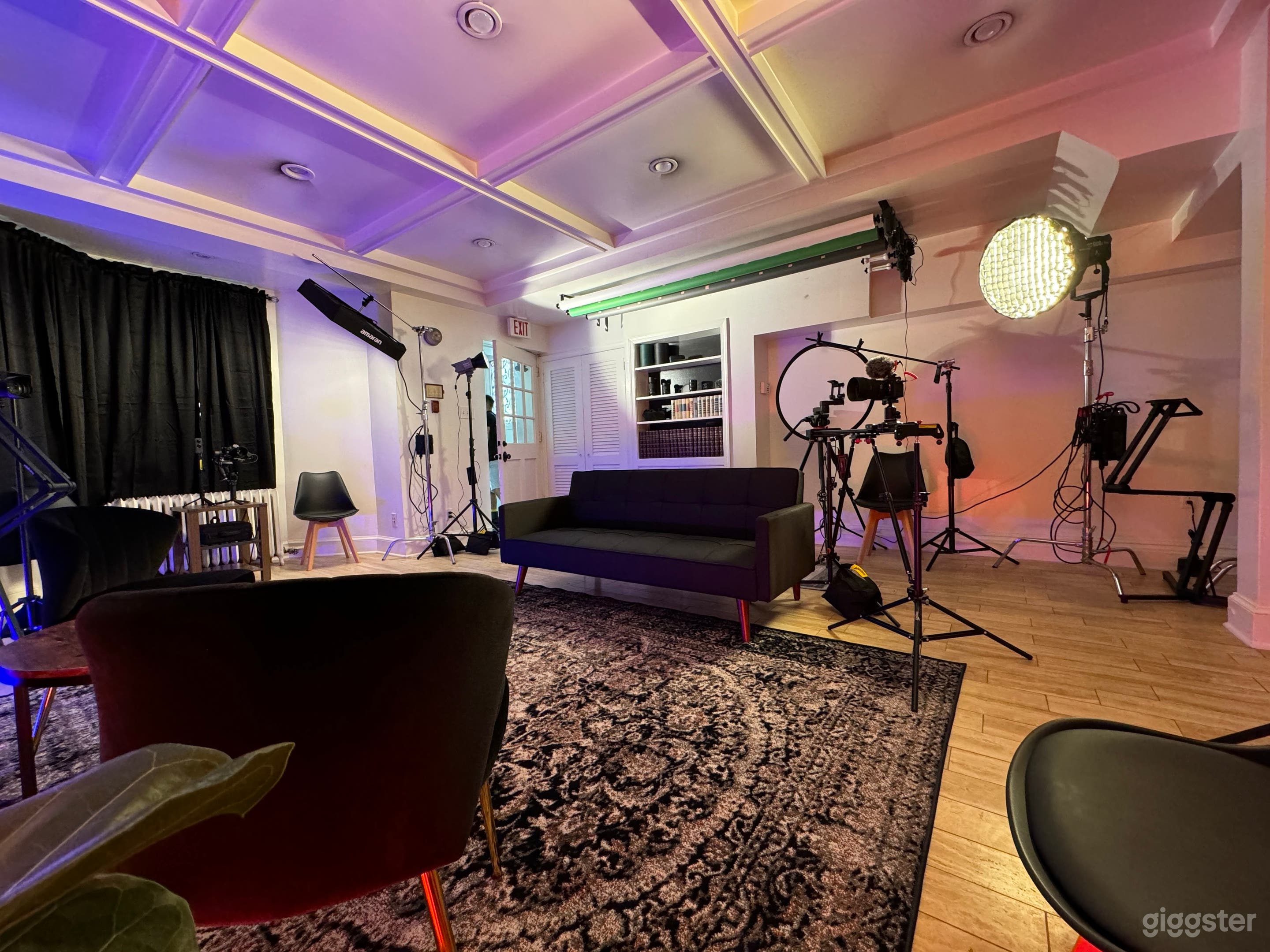 Main recording area with green, white, black and grey screens, lights, and blackout curtains.