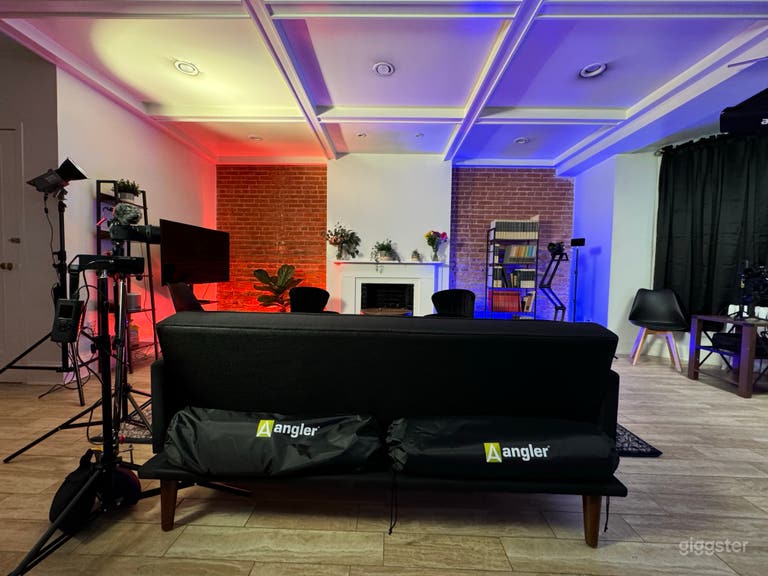  Main recording area with fireplace, bookshelves, lights, and blackout curtains. 