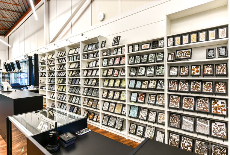  Cash counter with loose gemstones in the background 