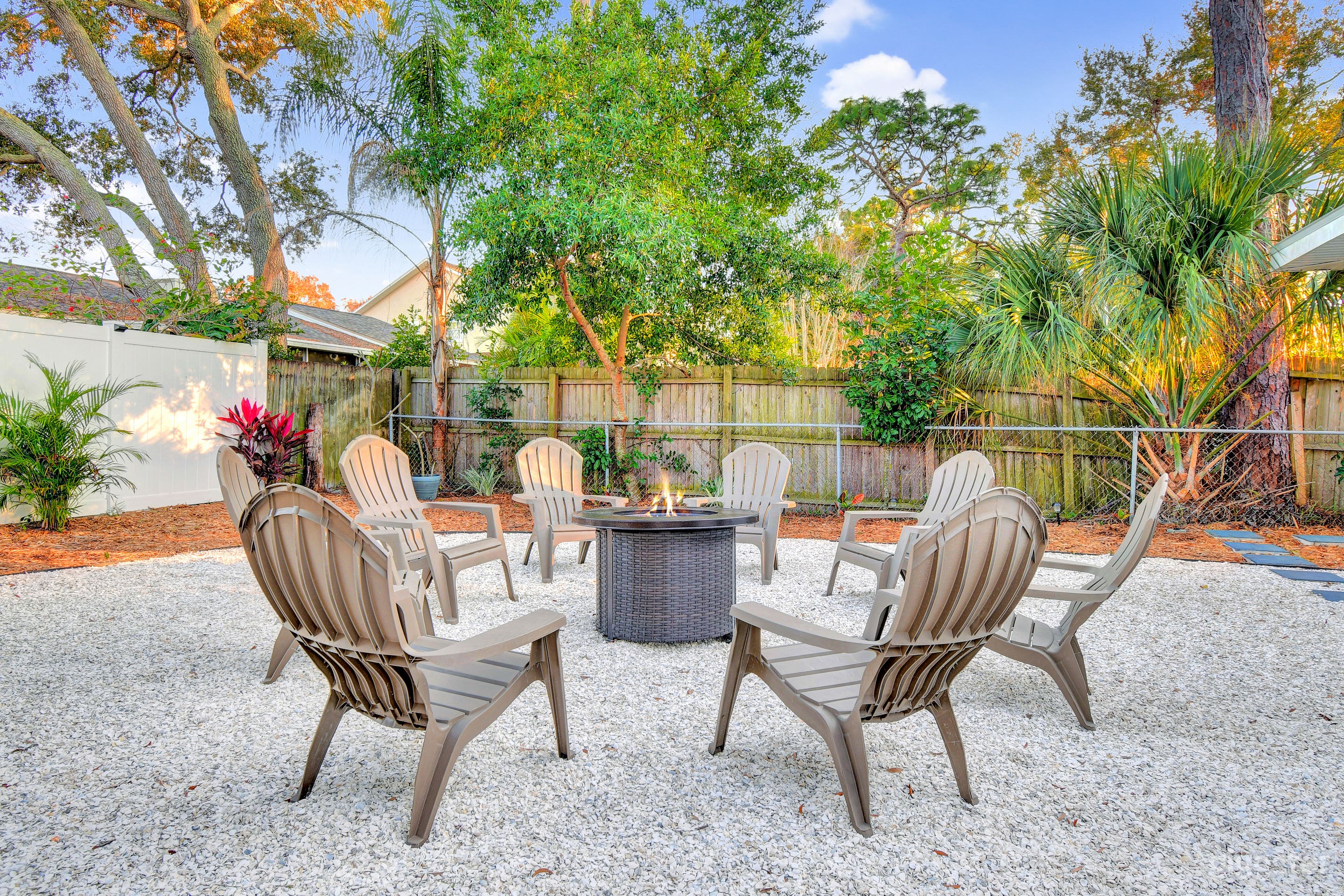 Outdoor fire pit amid lush tropical landscaping