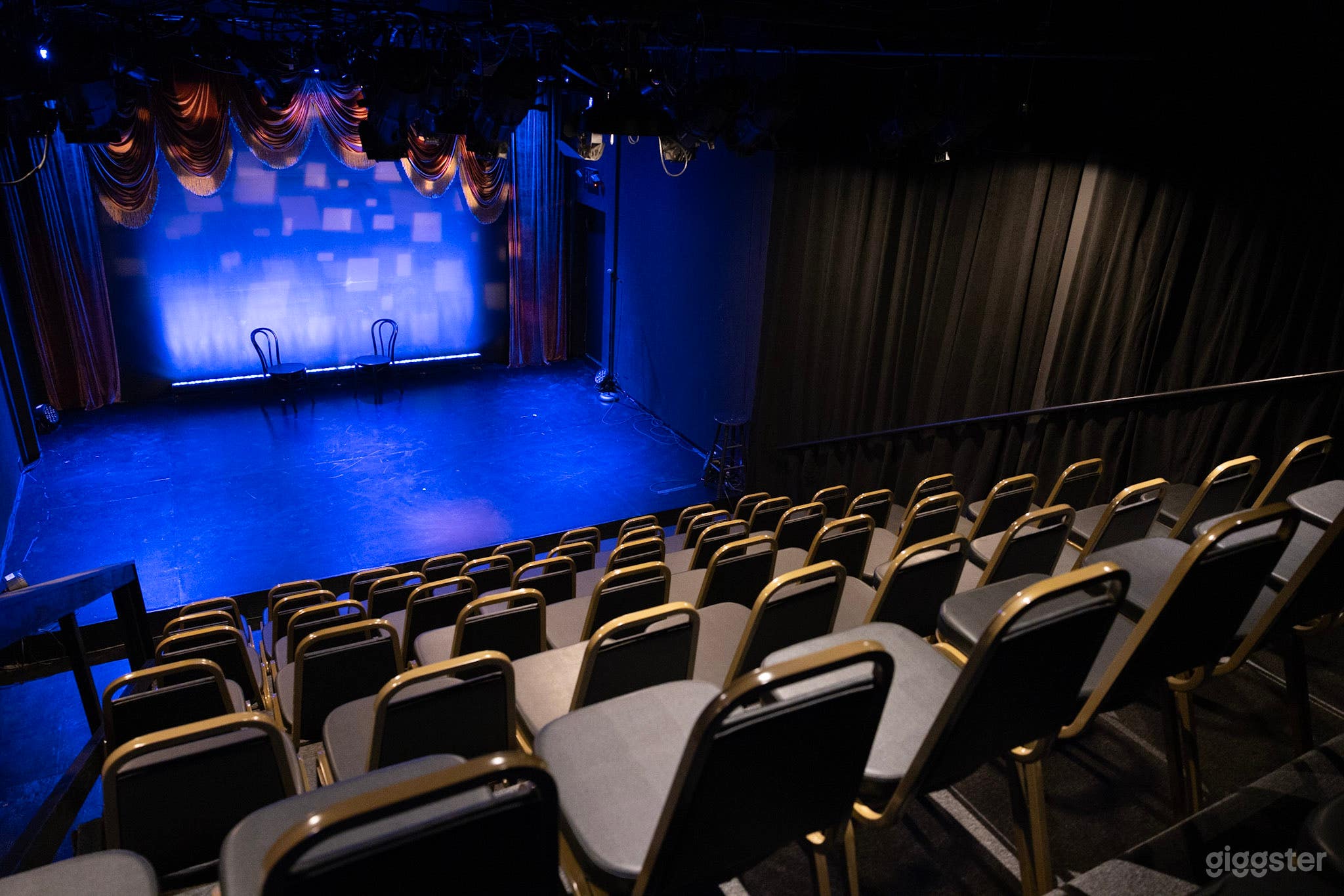 The set on stage is from a previous production. No curtains currently.