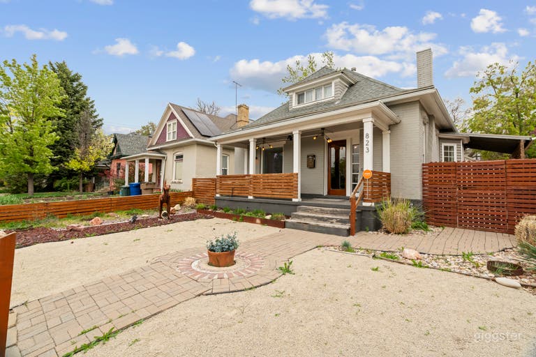  The xeriscaped front yard with native plants, brickwork pathways, and a whimsical rusted dino sculpture adds a layer of fun and authenticity—perfect for lifestyle shoots, interviews, or editorial content. 