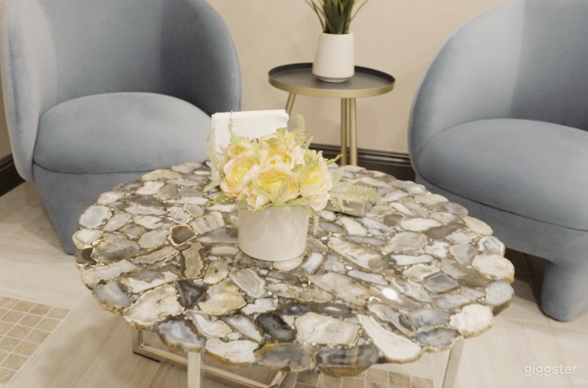 Our reception area showcases unique furniture pieces, featuring Italian marble, perfect for high-end shots. Experience the exclusivity of our meticulously curated space.
