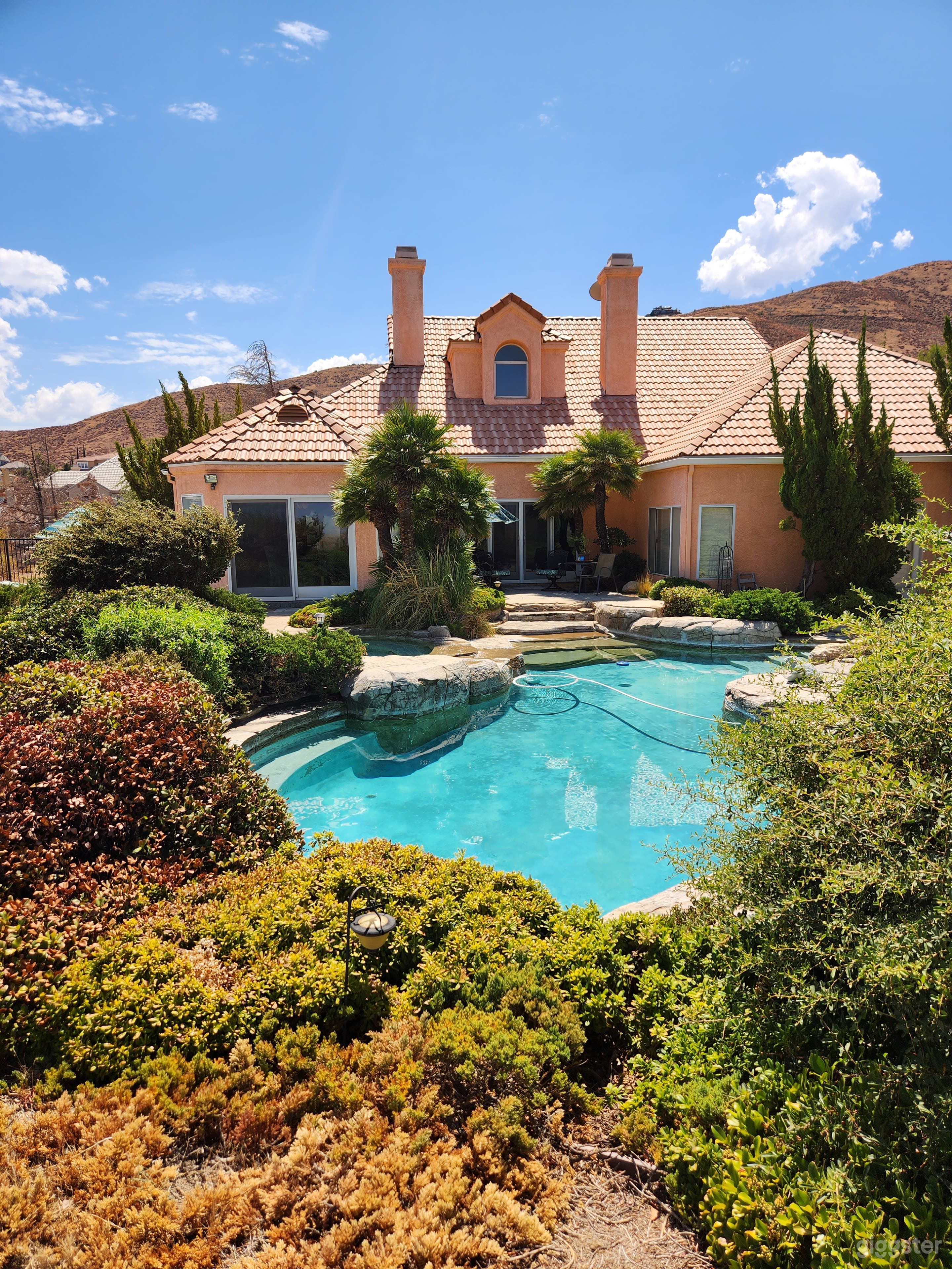 Back of house view and pool.