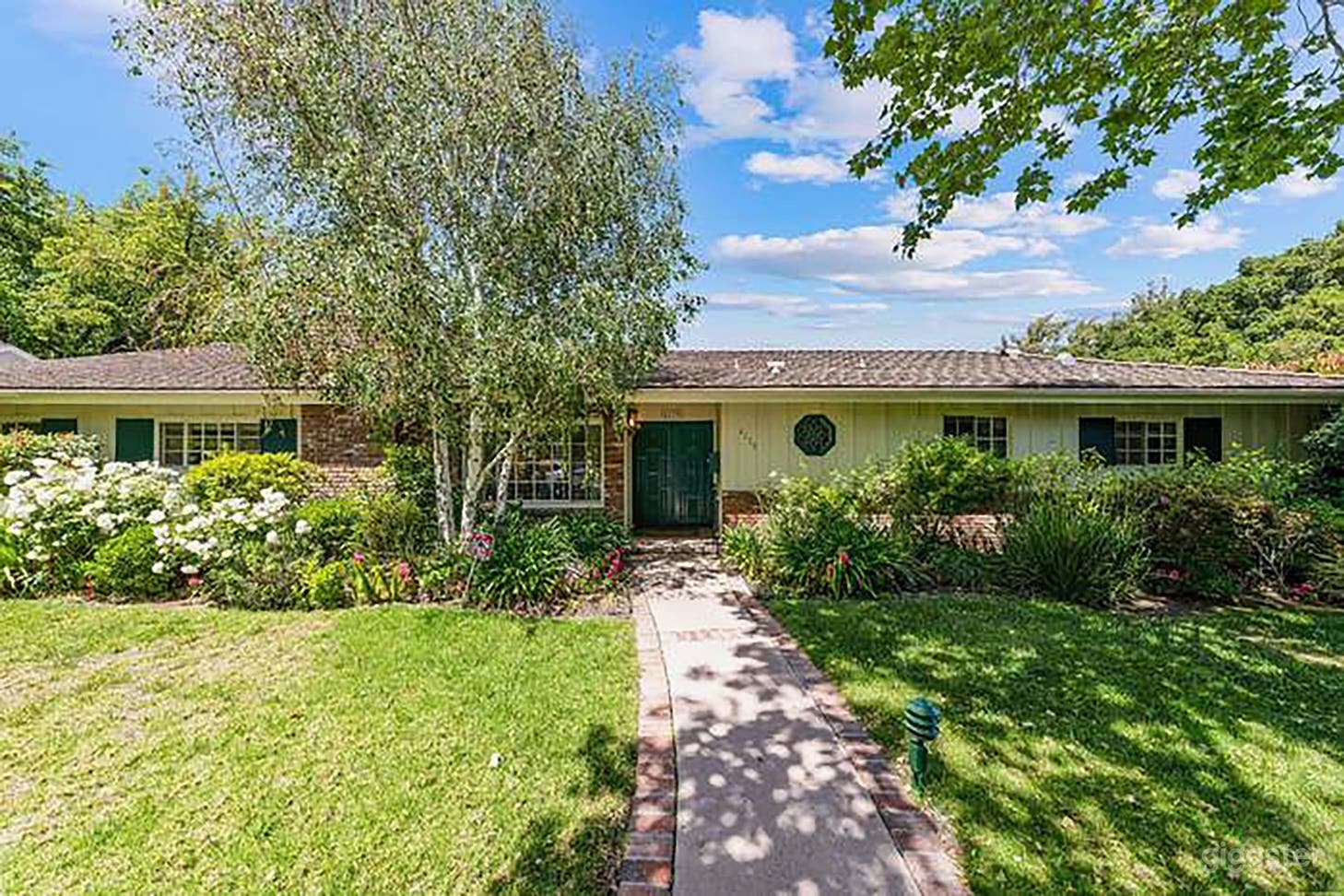 Sprawling front yard with full gardens