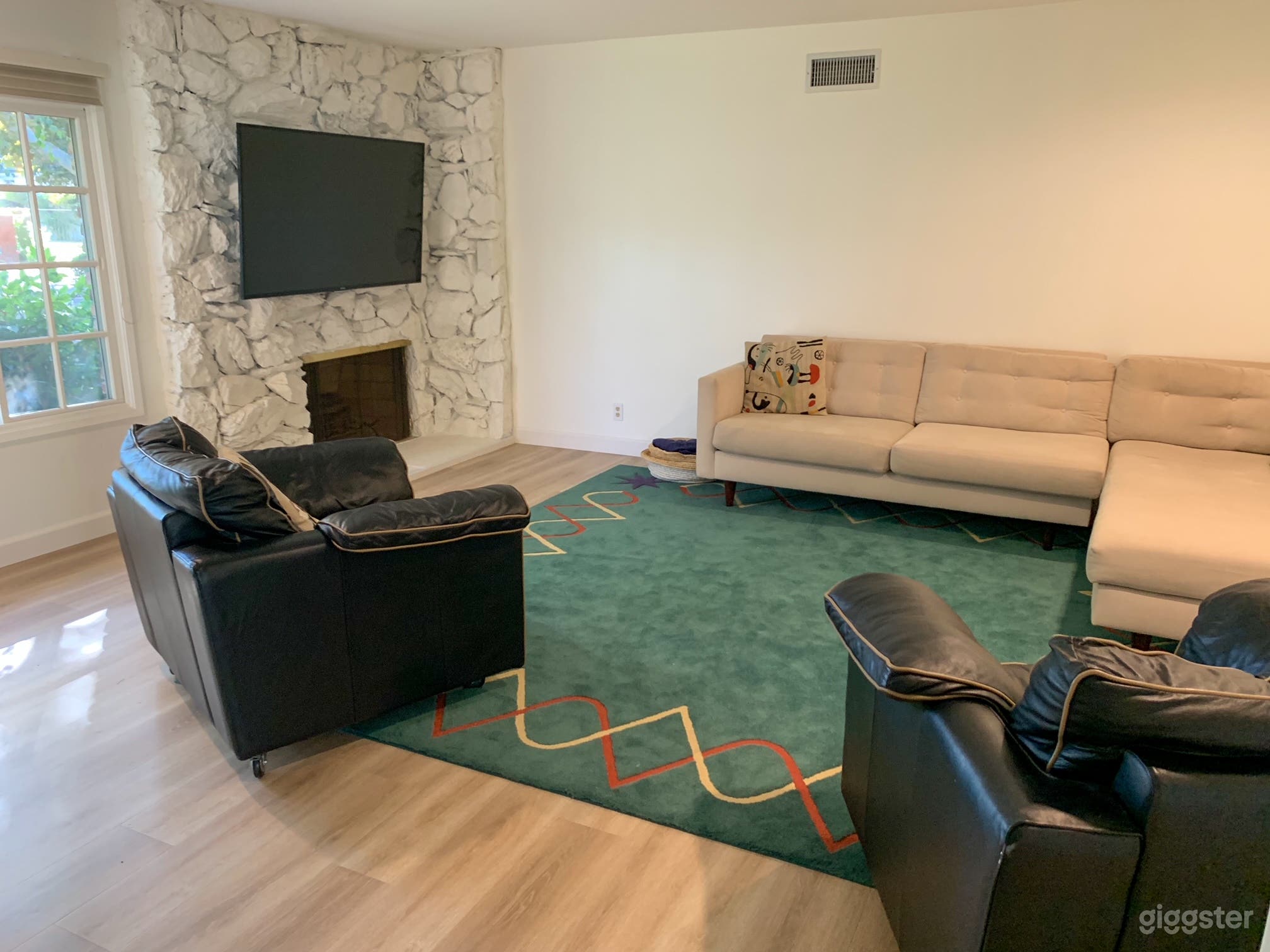 Living room full of natural light with fireplace looking out onto front yard