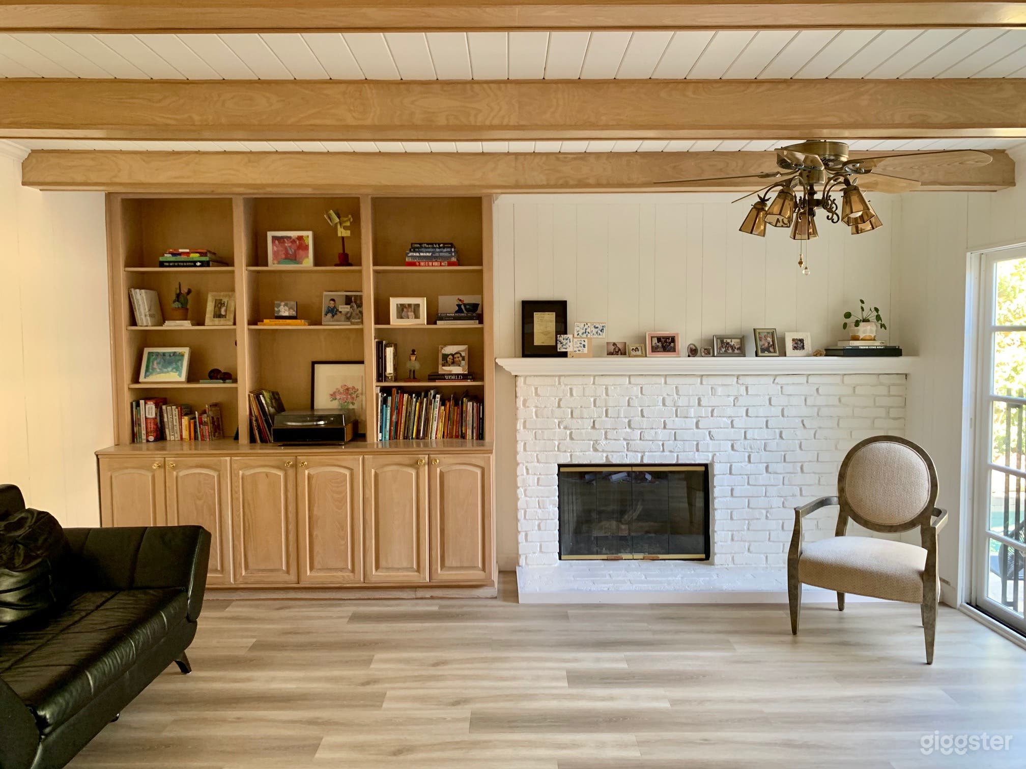 Game Room with white brick fireplace looking out onto backyard patio and pool