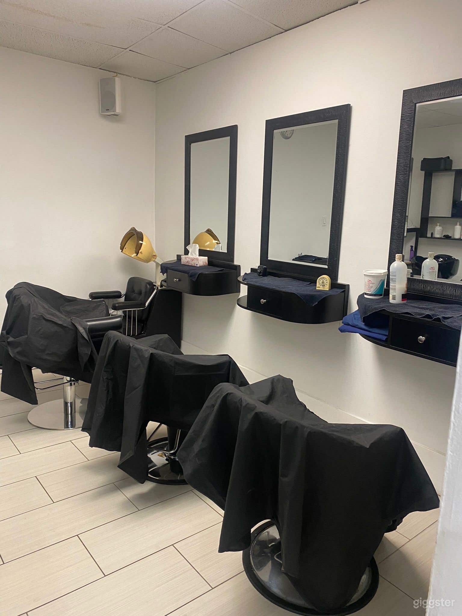 Three styling chairs located at the back of the salon.