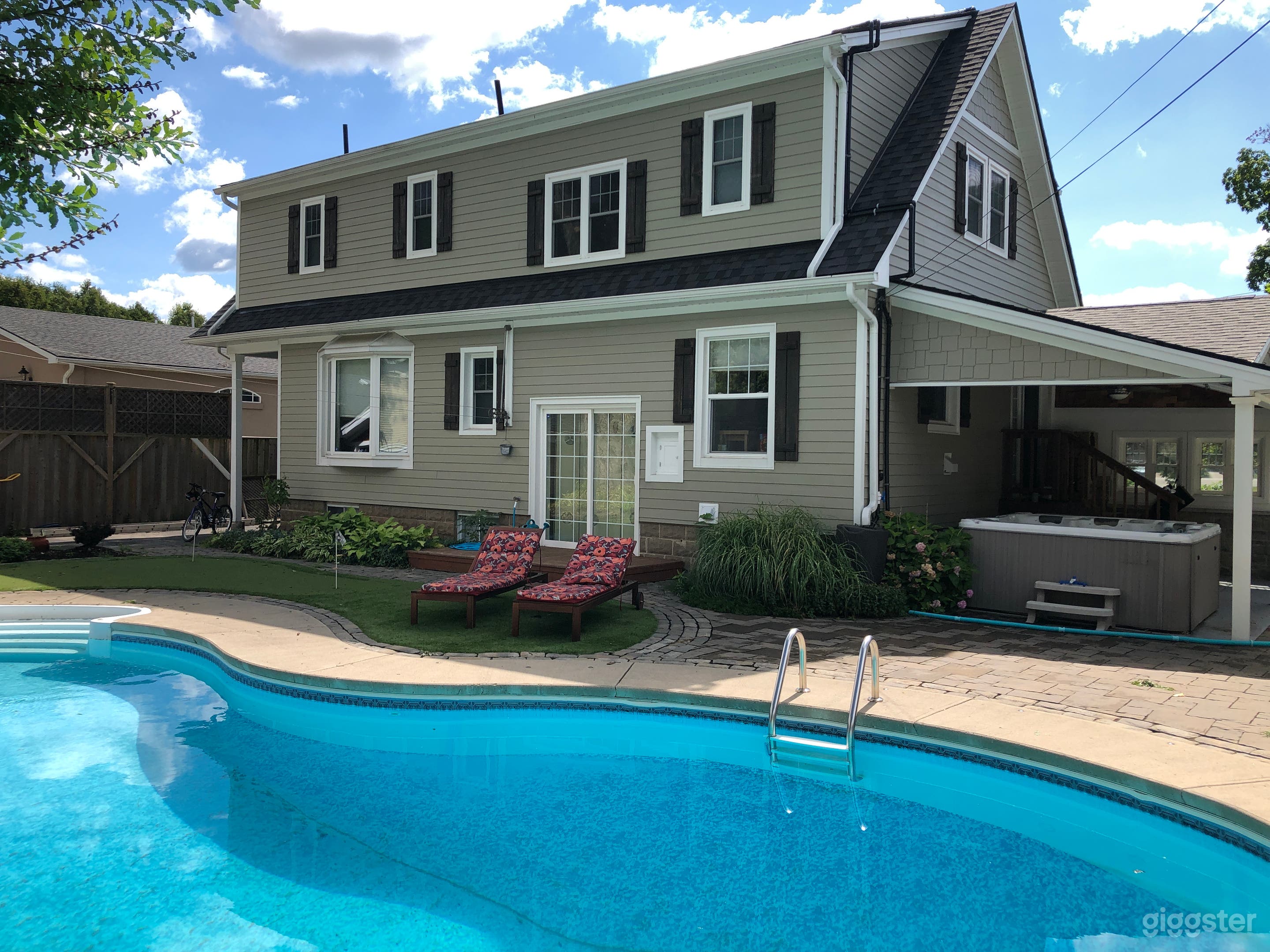 Back of house, pool, putting green.