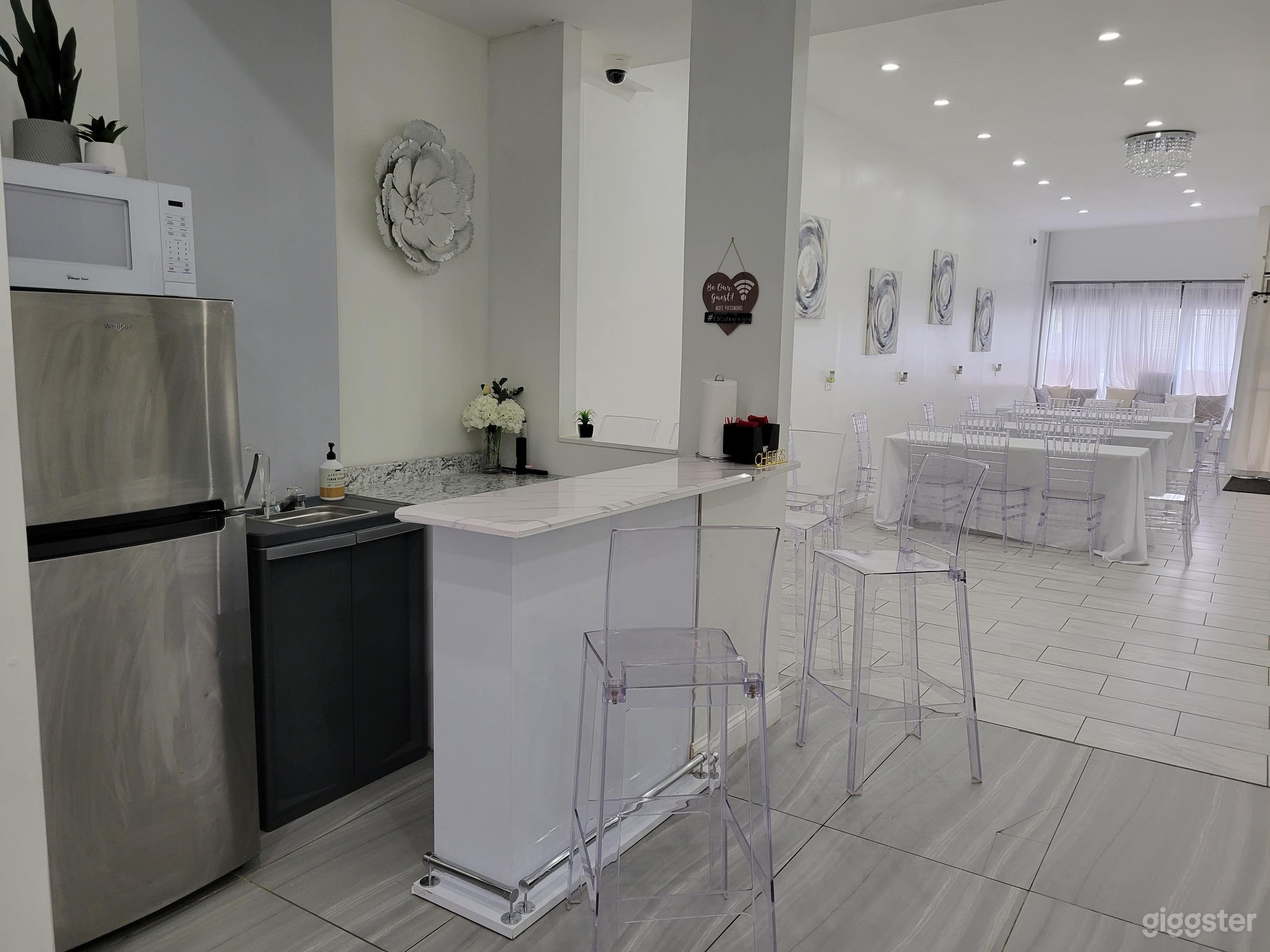 Kitchenette with refrigerator and beverage serving area.