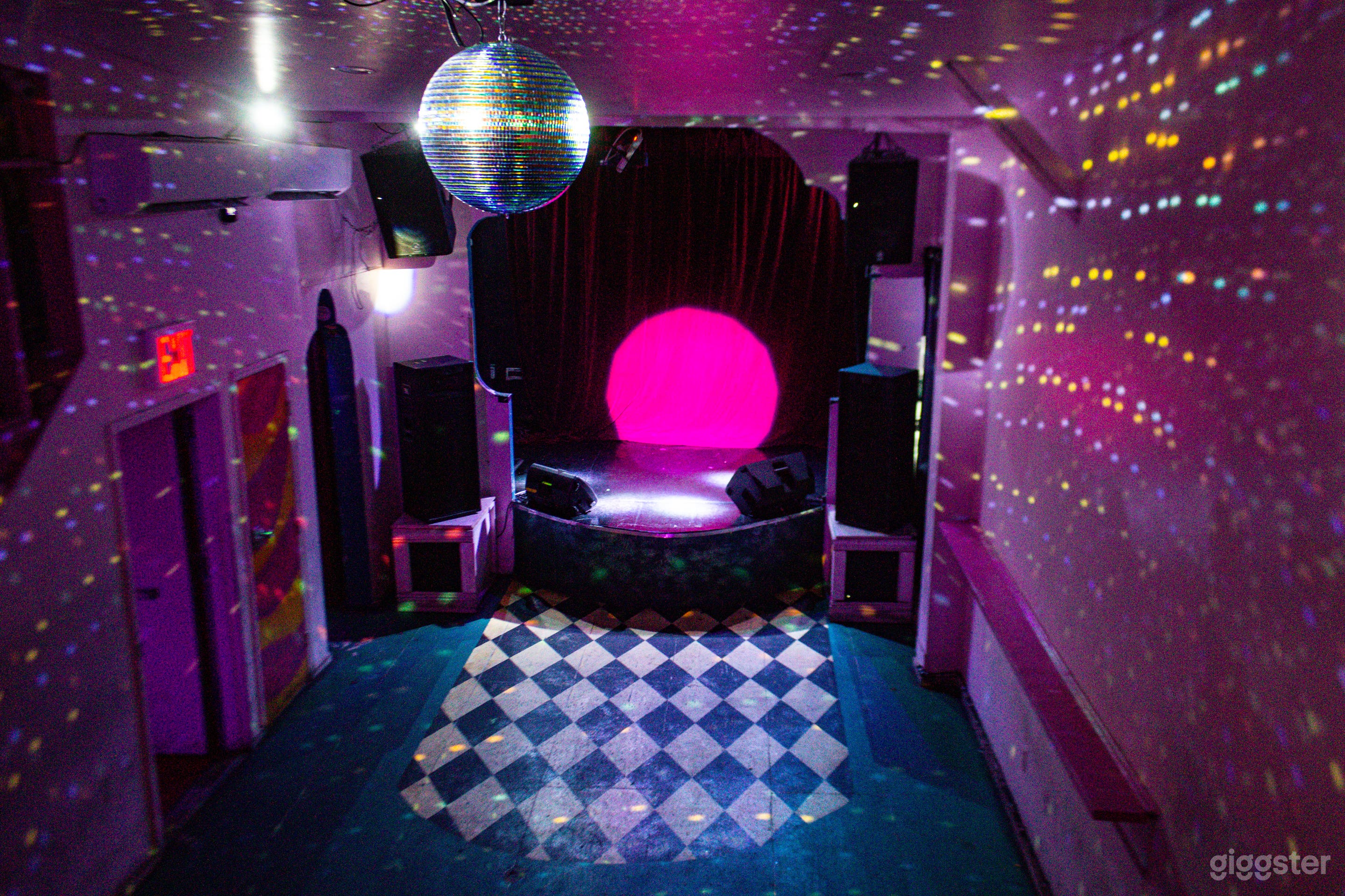 Our main venue features blackout curtains, a disco ball, and A/V capabilities.