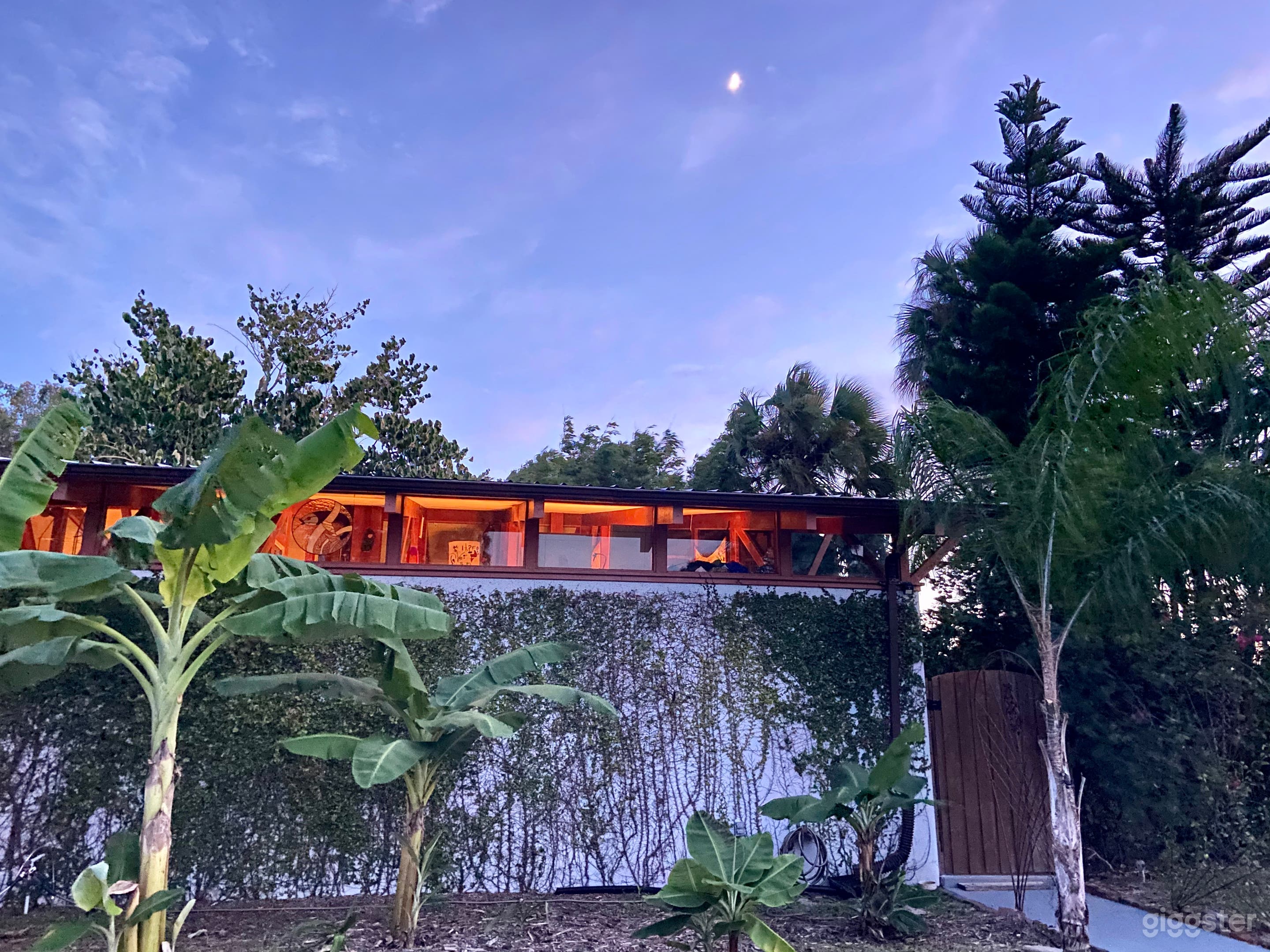 View of front west side with banana trees on a Florida summer night 