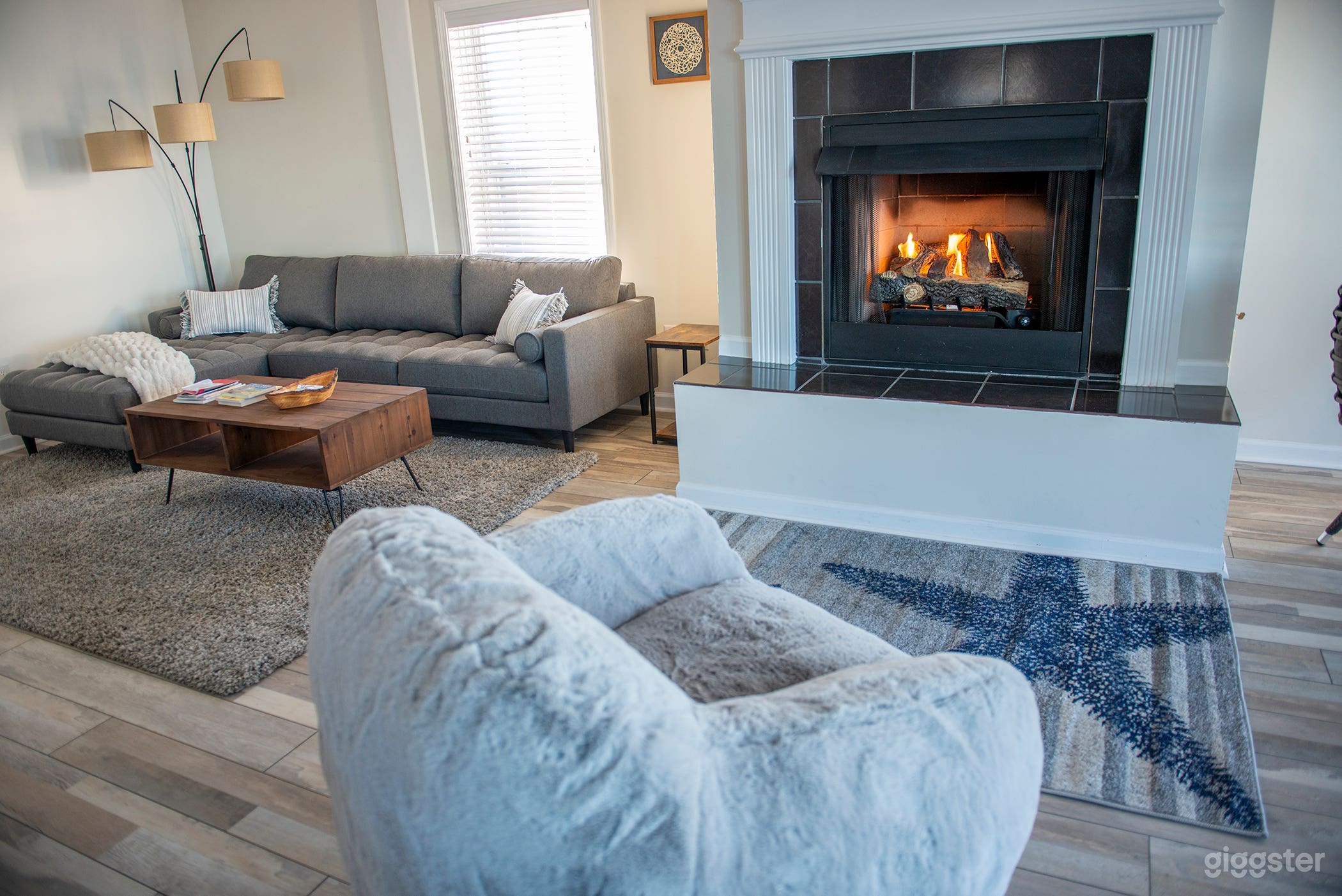 Living room with sectional sofa, fireplace and comfy bean bag chair.