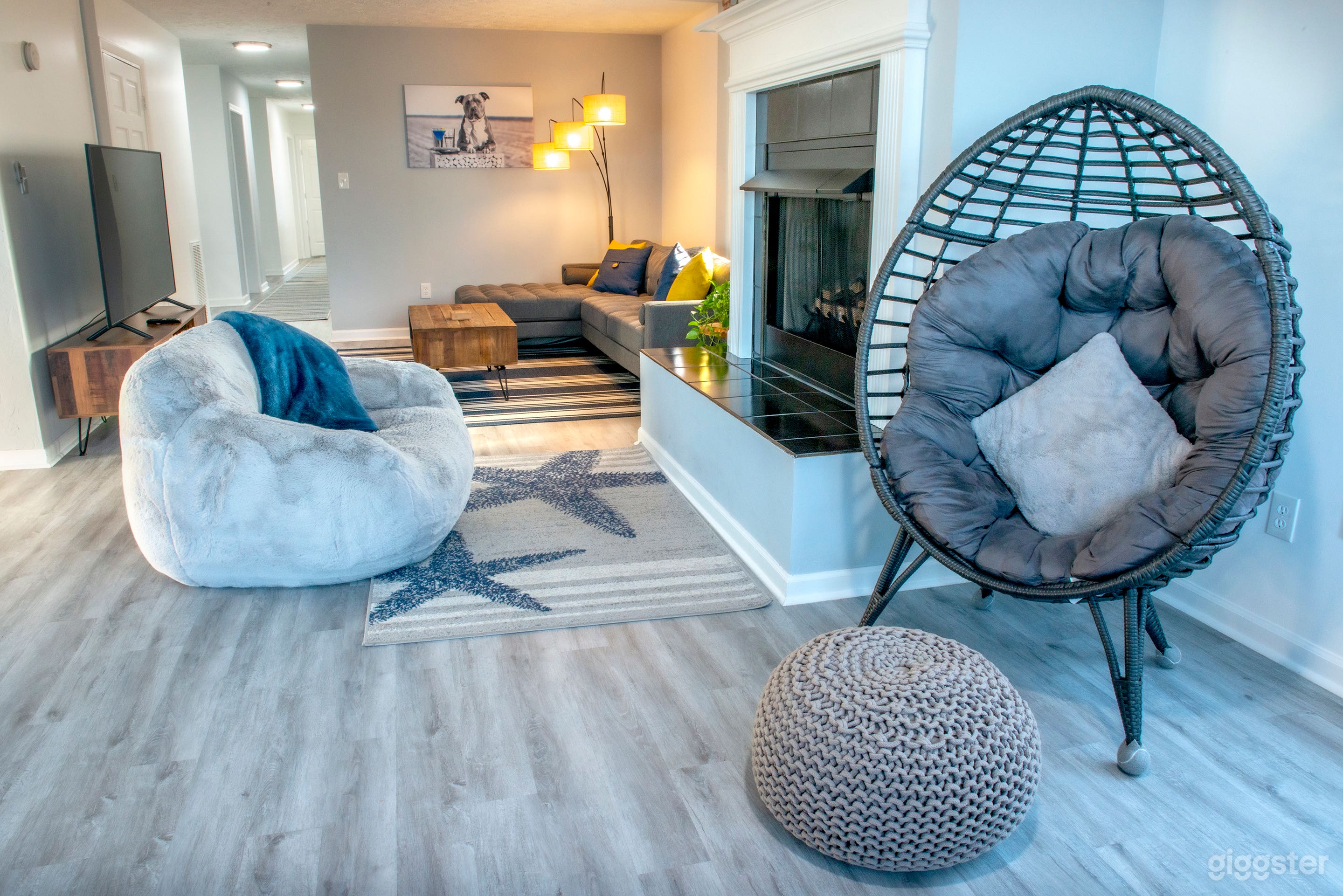 Living room with TV, sectional sofa, fireplace and comfy bean bag chair.