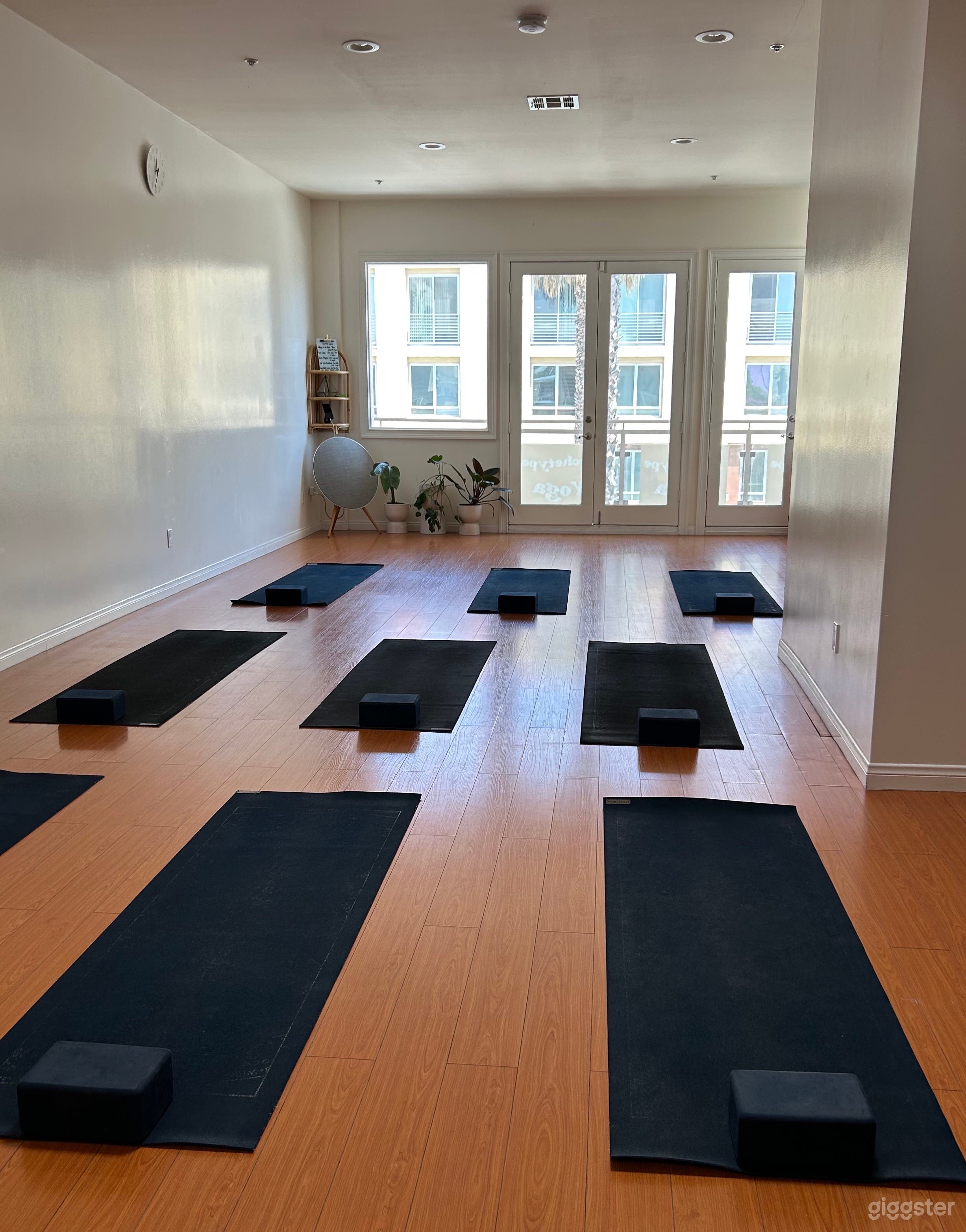 Airy Loft | Yoga Space with White Walls and Honey-Colored Floors Photo 1
