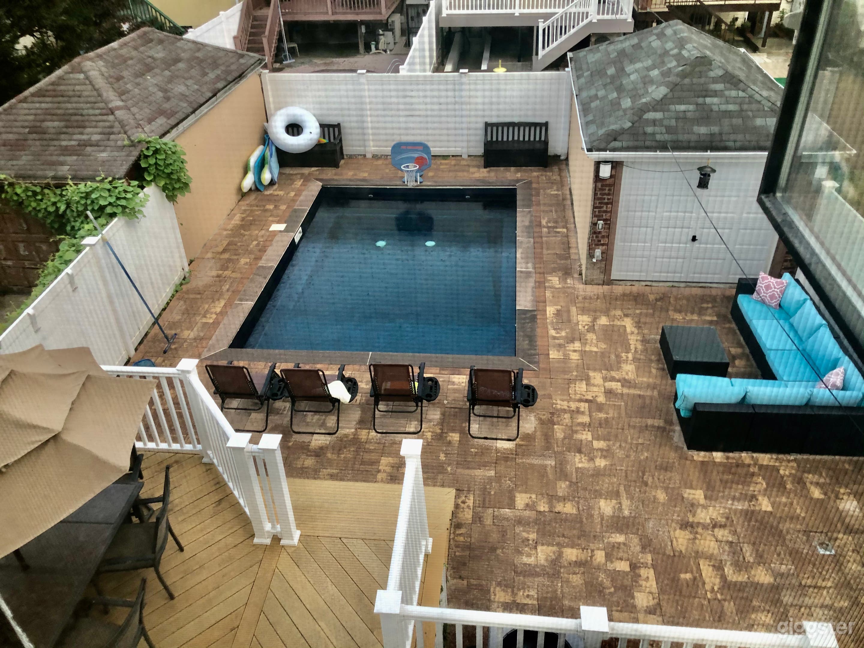 Large yard with new inground pool and neutral toned pavers 