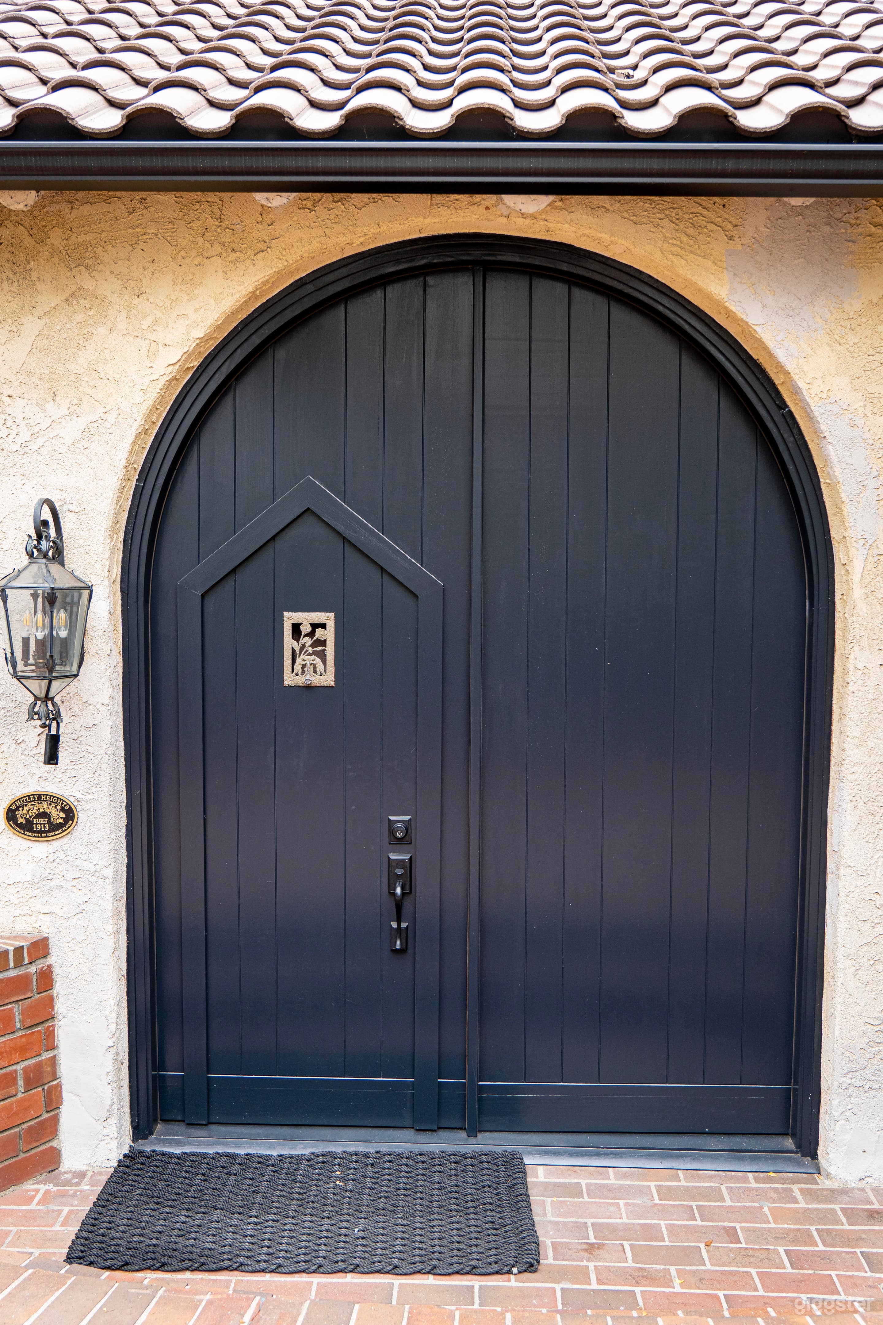 Exterior shot of large front doors which include wicket door