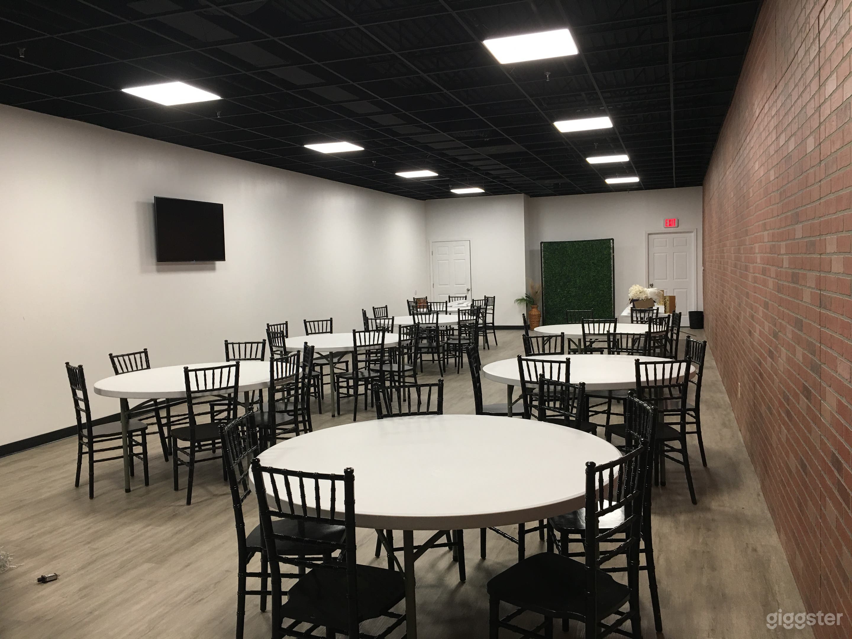 Event/studio space w/brick wall, black ceiling Photo 1