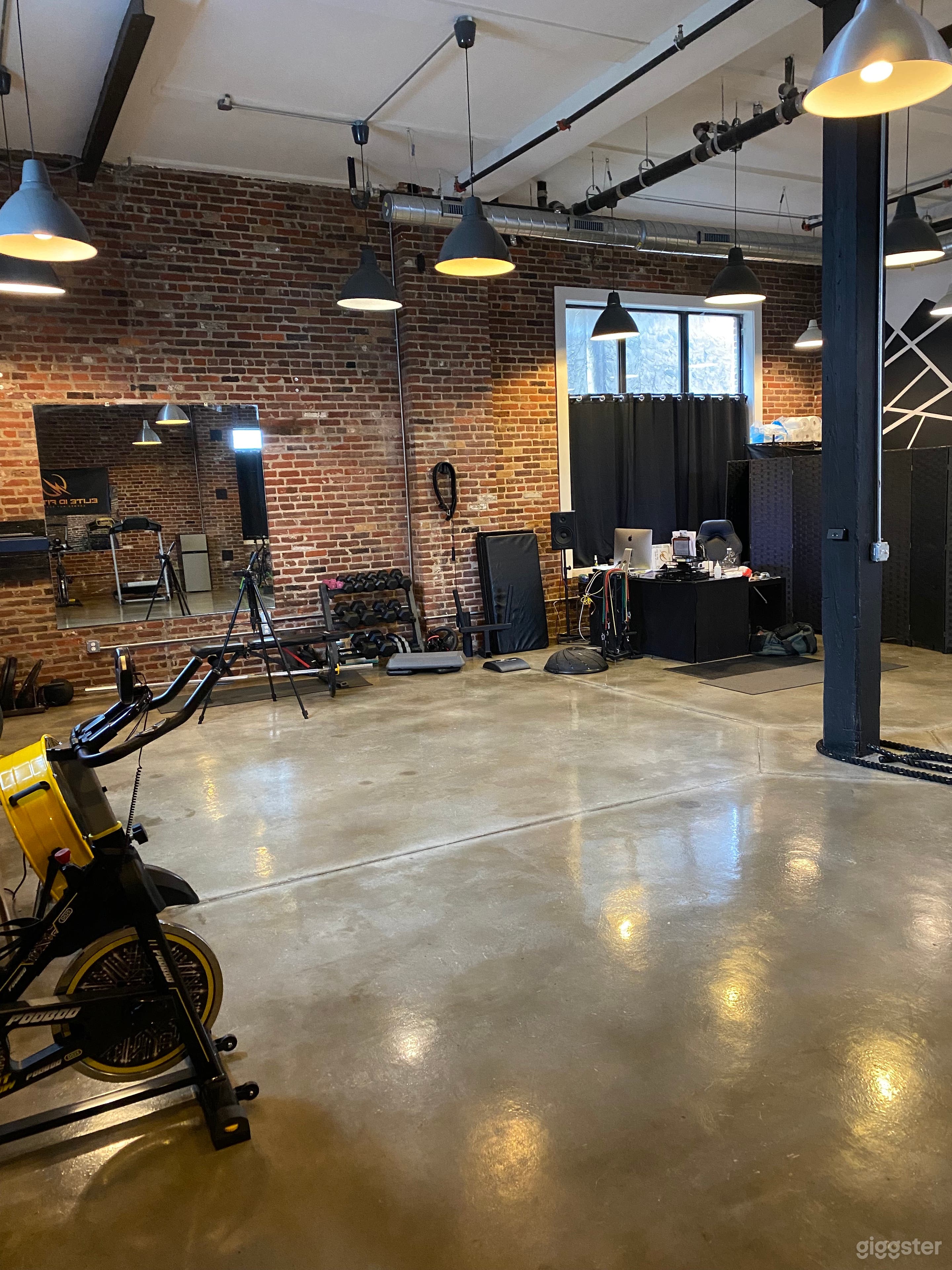 A wide open section of the gym floor ideal for hosting group fitness classes, private training, or wellness sessions. 