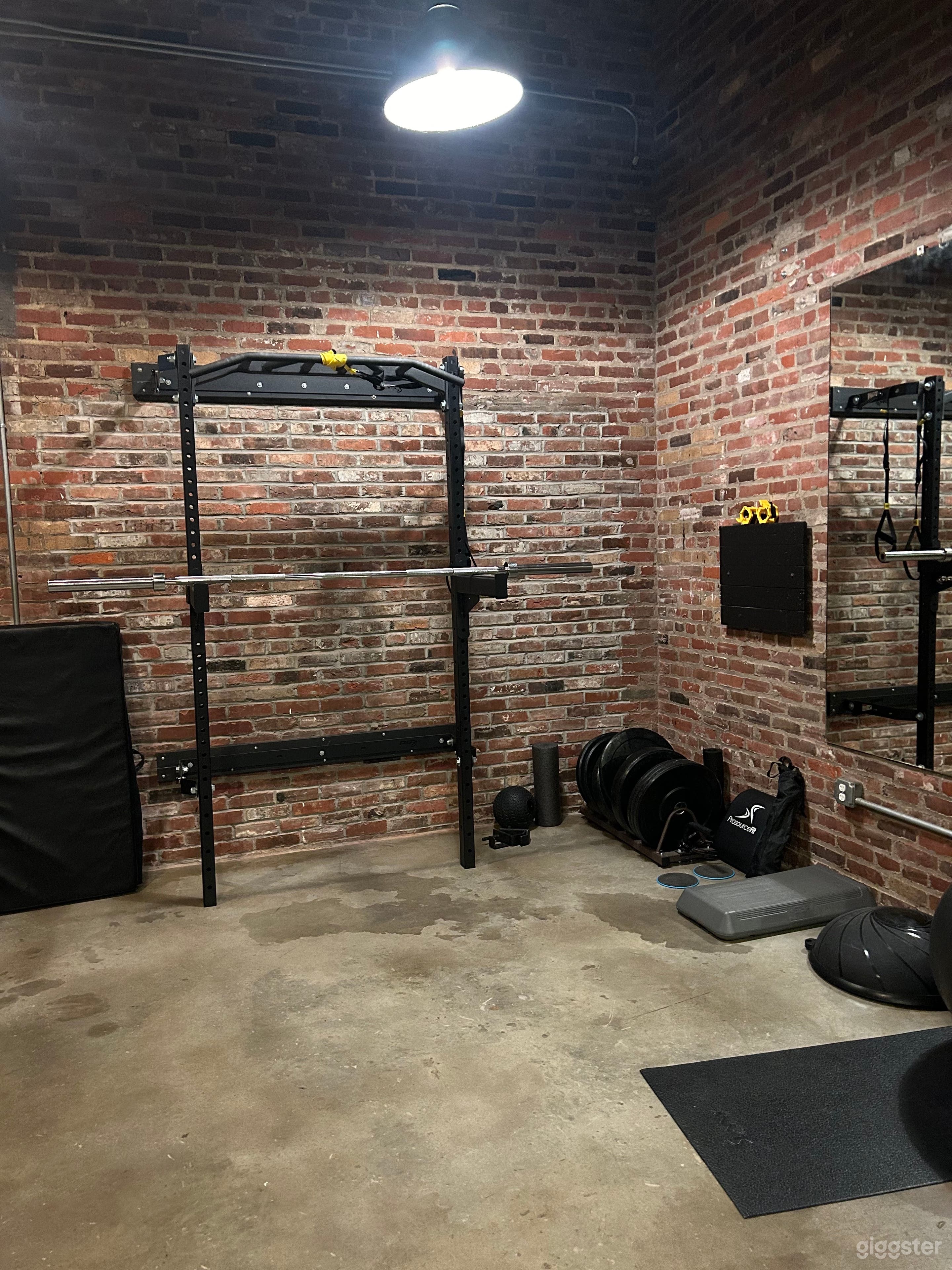 A sleek foldable squat rack with barbell designed to be easily stored against the wall for maximum space flexibility. Perfect for multi-use setups.