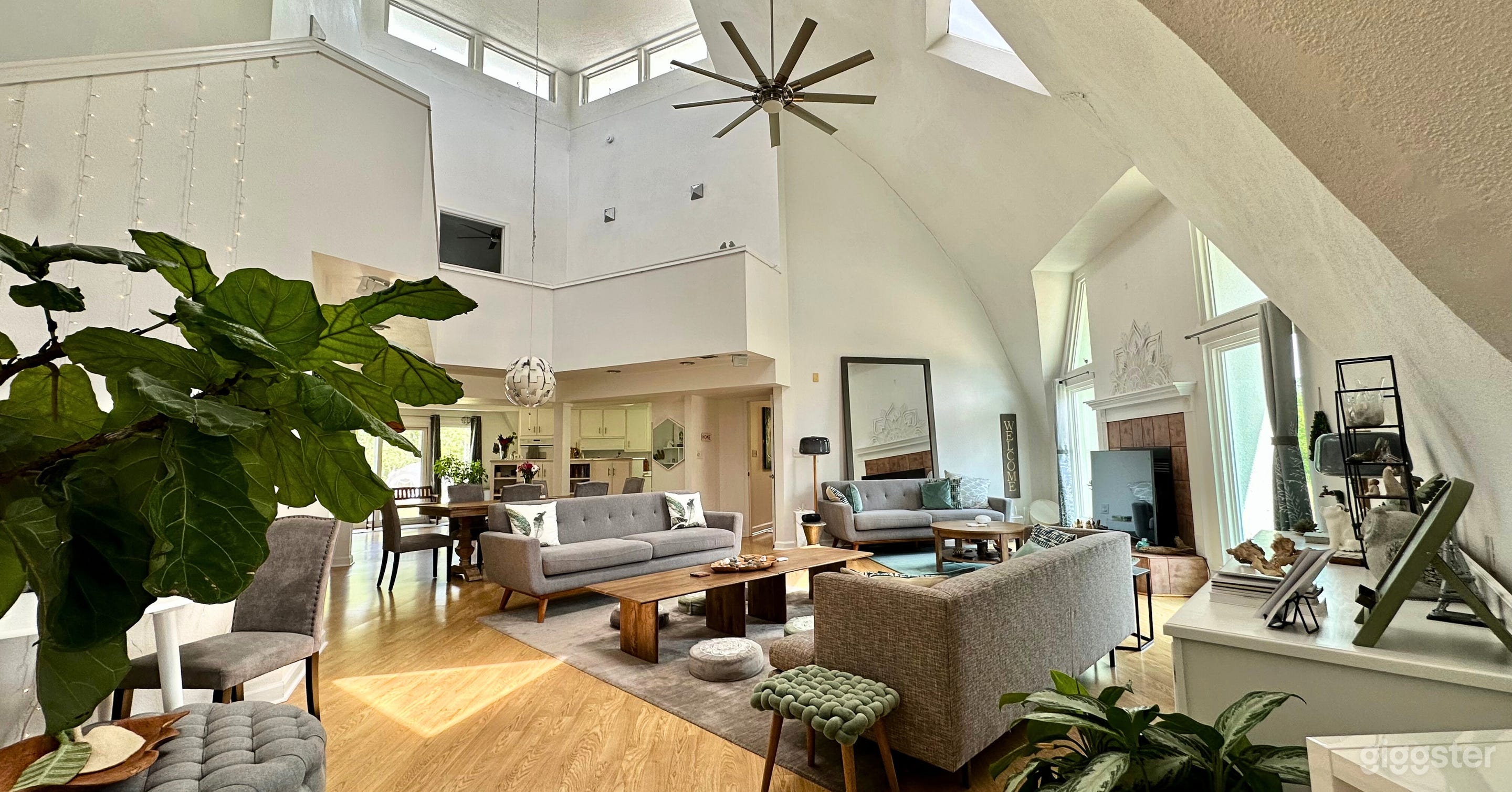 Main living room with natural lighting, beautiful decor, and vibrant energy. 