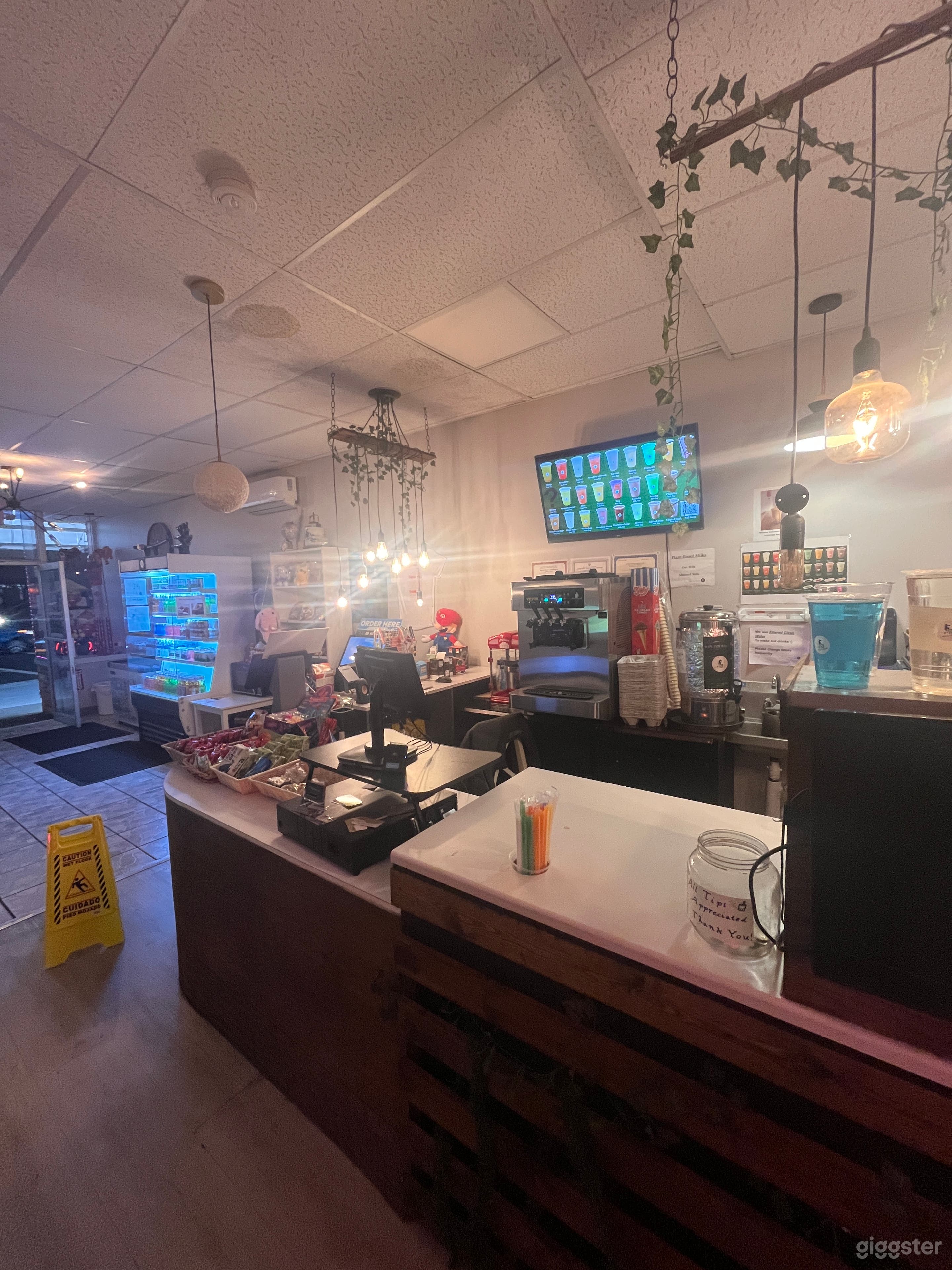 Open kitchen with floral tones and dangling energy efficient lights
