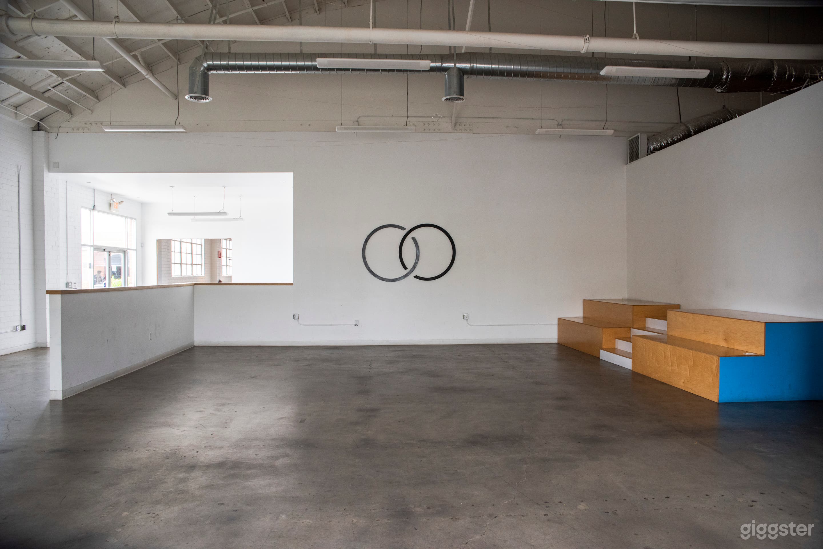 The Gallery - Concrete floors, high ceilings, white walls, beer barrels &amp; clean industrial chic (stadium steps no longer exist)