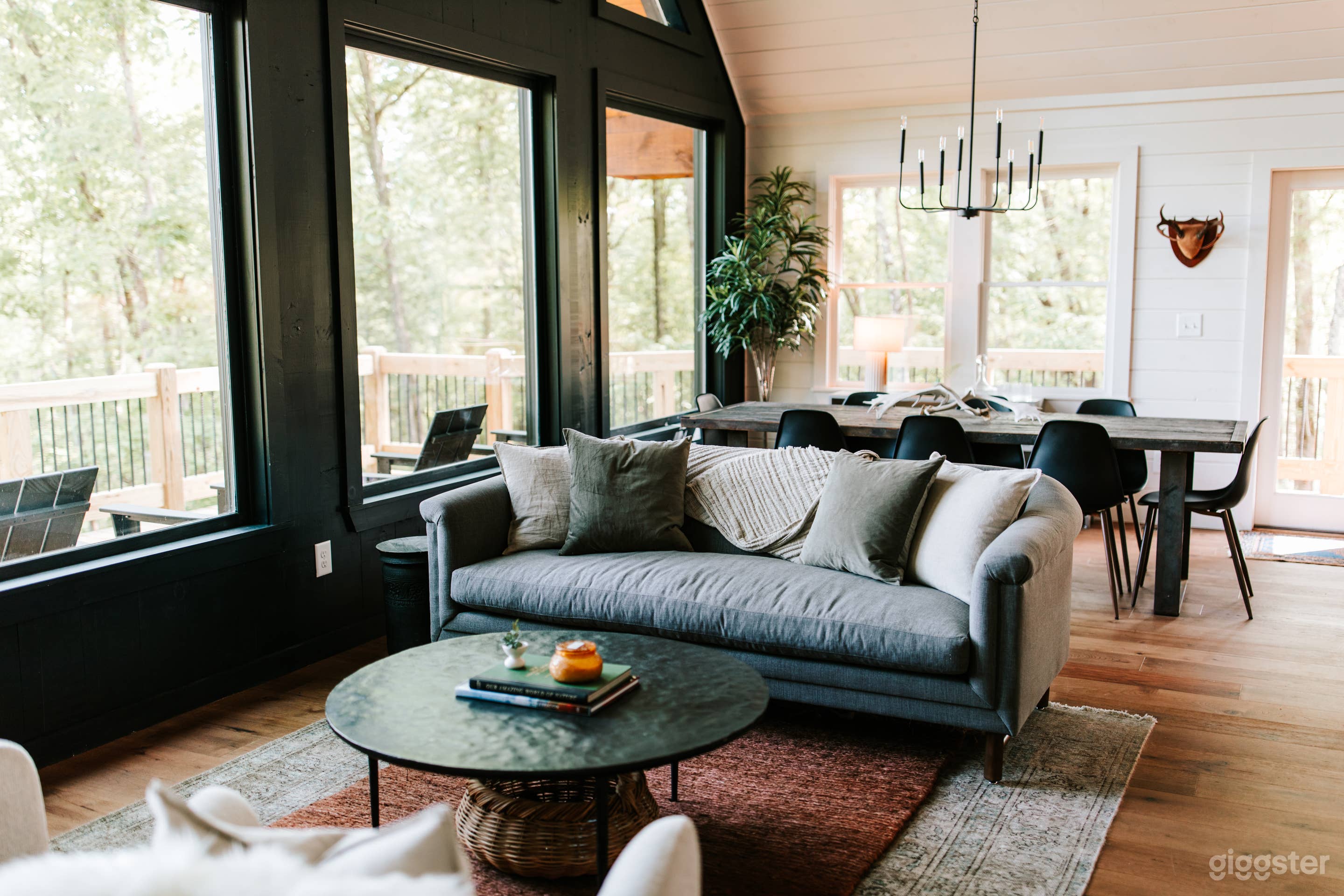 Main level living room with large windows with mountain view. 