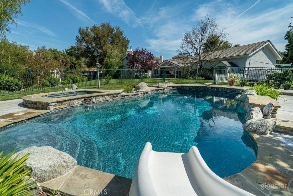 Expansive Outdoor Space with Pool, Lawn, &amp; Bridge Photo 3