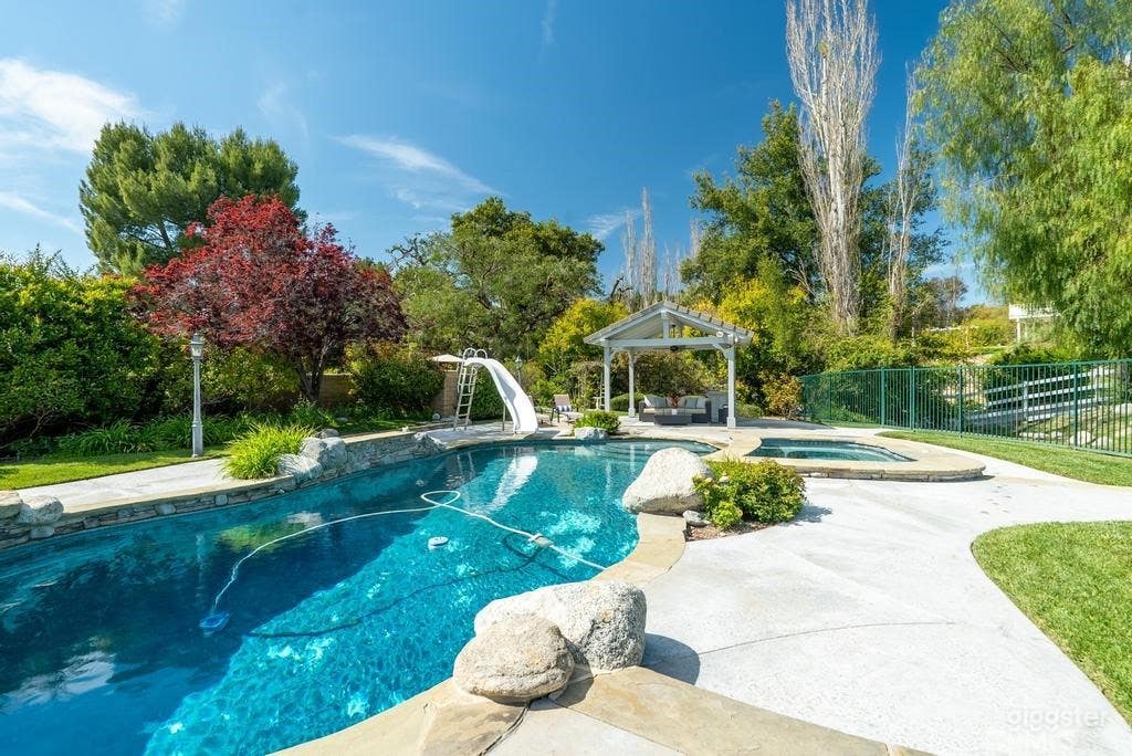 Expansive Outdoor Space with Pool, Lawn, &amp; Bridge Photo 2