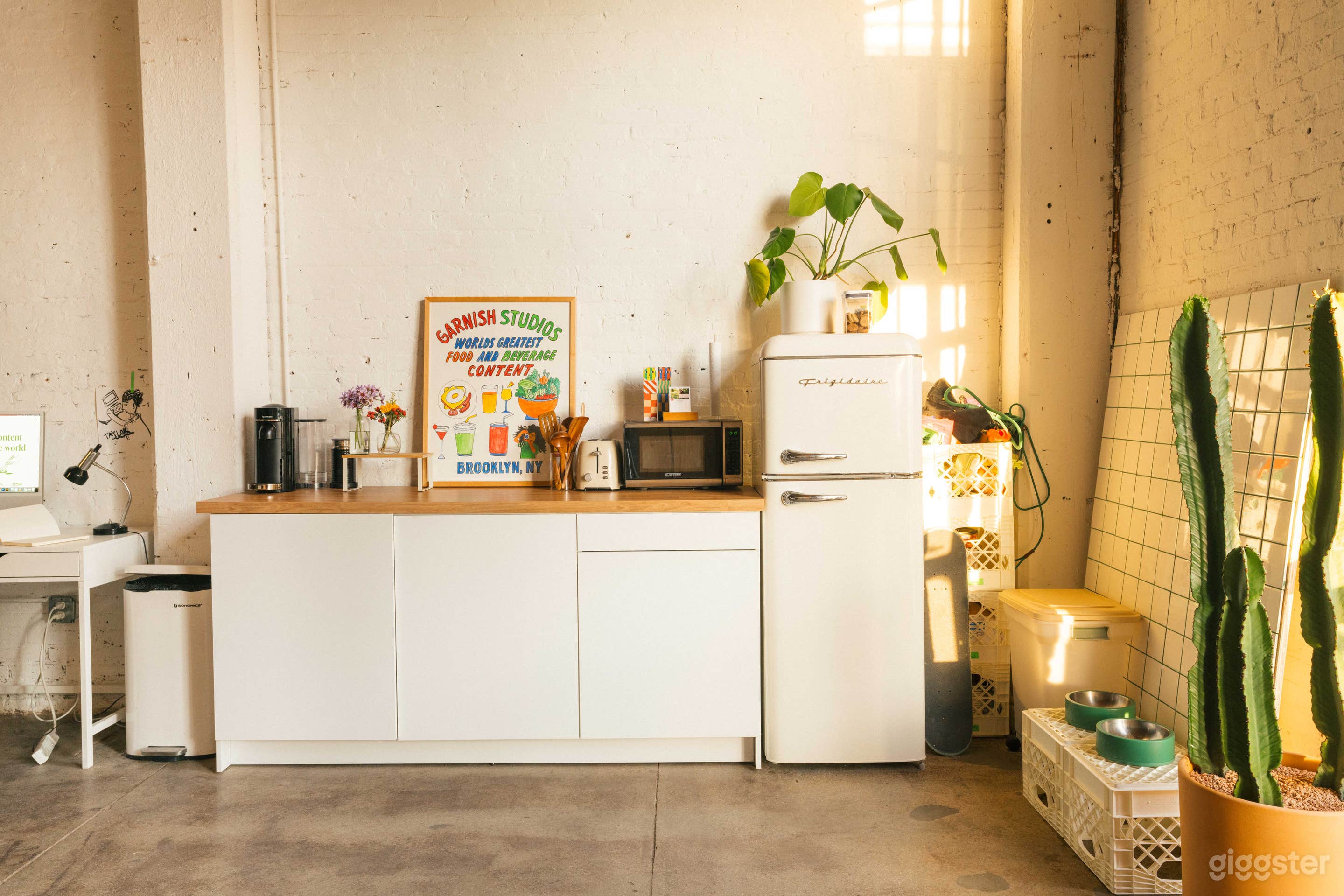 A small kitchenette that includes a fridge, microwave, and countertop space for any catering and beverage crafting. 