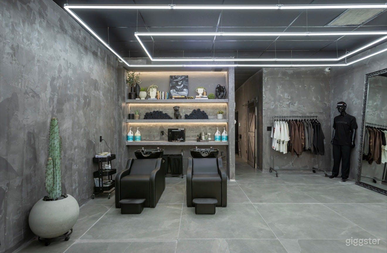 Luxury shampoo lounge and editorial-style grooming area featuring geometric LED lighting, textured concrete walls, oversized mirrors, and a clean modern-industrial aesthetic.

Perfect for:
• Grooming campaigns  
• Fashion/editorial shoots  
• Music videos  
• Podcast filming  
• Lifestyle content  
• Social media productions

Designed to feel cinematic, elevated, and visually impactful on camera.